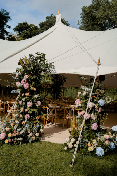 floral and foliage arch entrance to marquee reception