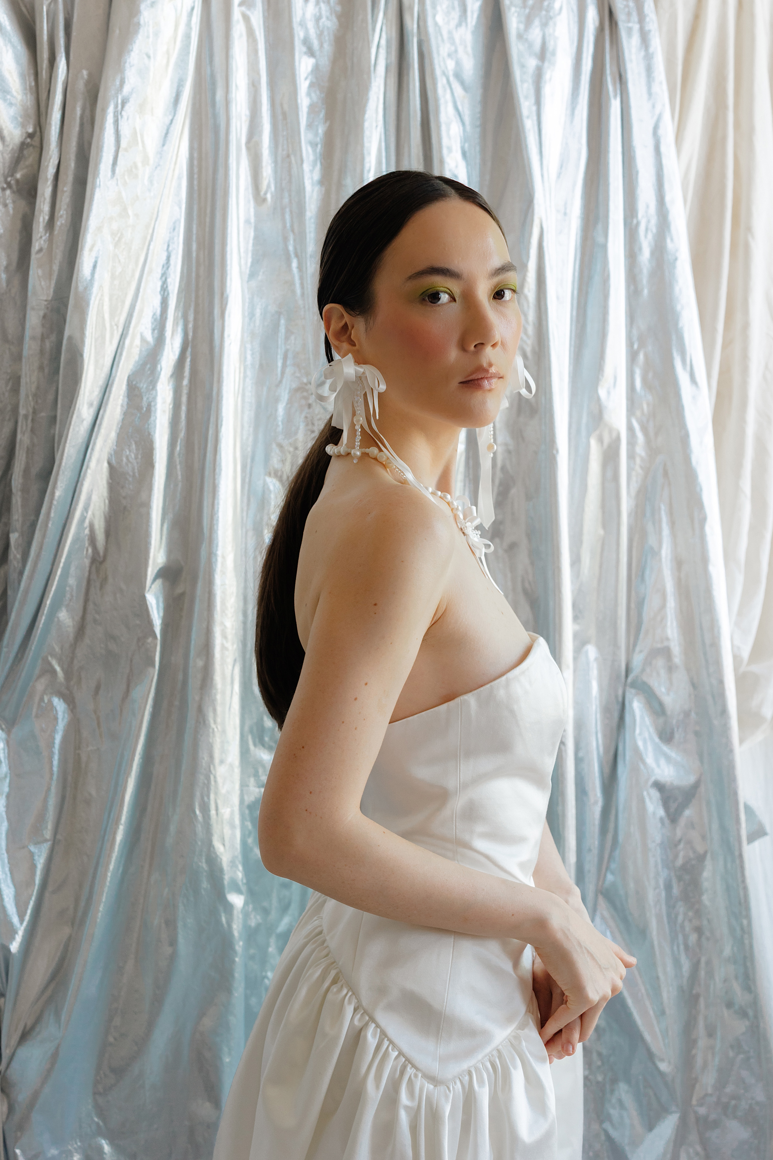 RLE Bride Studio Casso 011 - A Contemporary East Asian Inspired Bridal Fashion Editorial, Featuring RLE Bride Modern bride wearing RLE bride. She wears ribbon earrings and has her hair tied in a pony tail. Wolf & Co Photography.