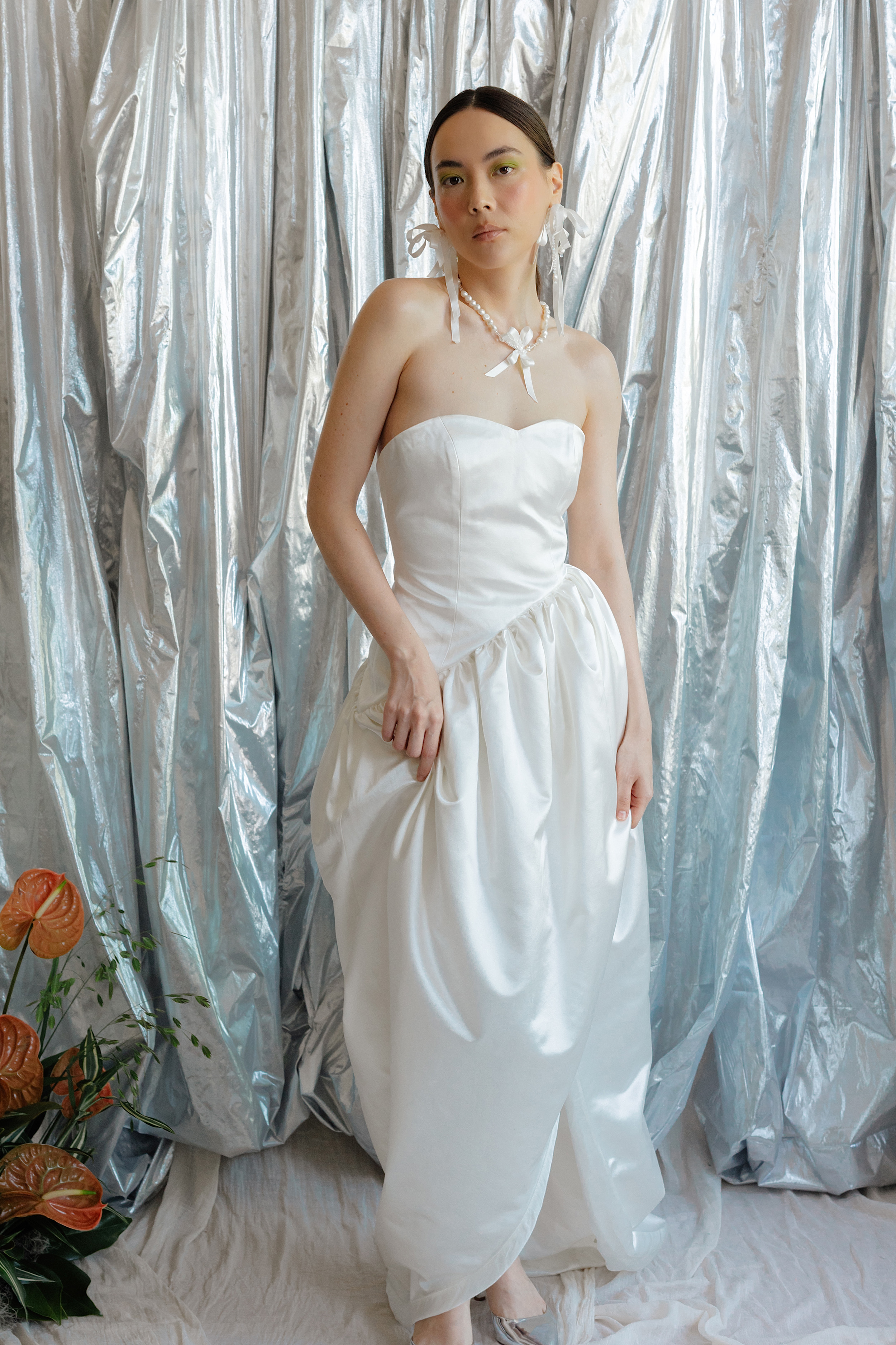 RLE Bride Studio Casso 020 1 - A Contemporary East Asian Inspired Bridal Fashion Editorial, Featuring RLE Bride Modern bride wearing RLE bride. She wears ribbon earrings and has her hair tied in a pony tail. Wolf & Co Photography.