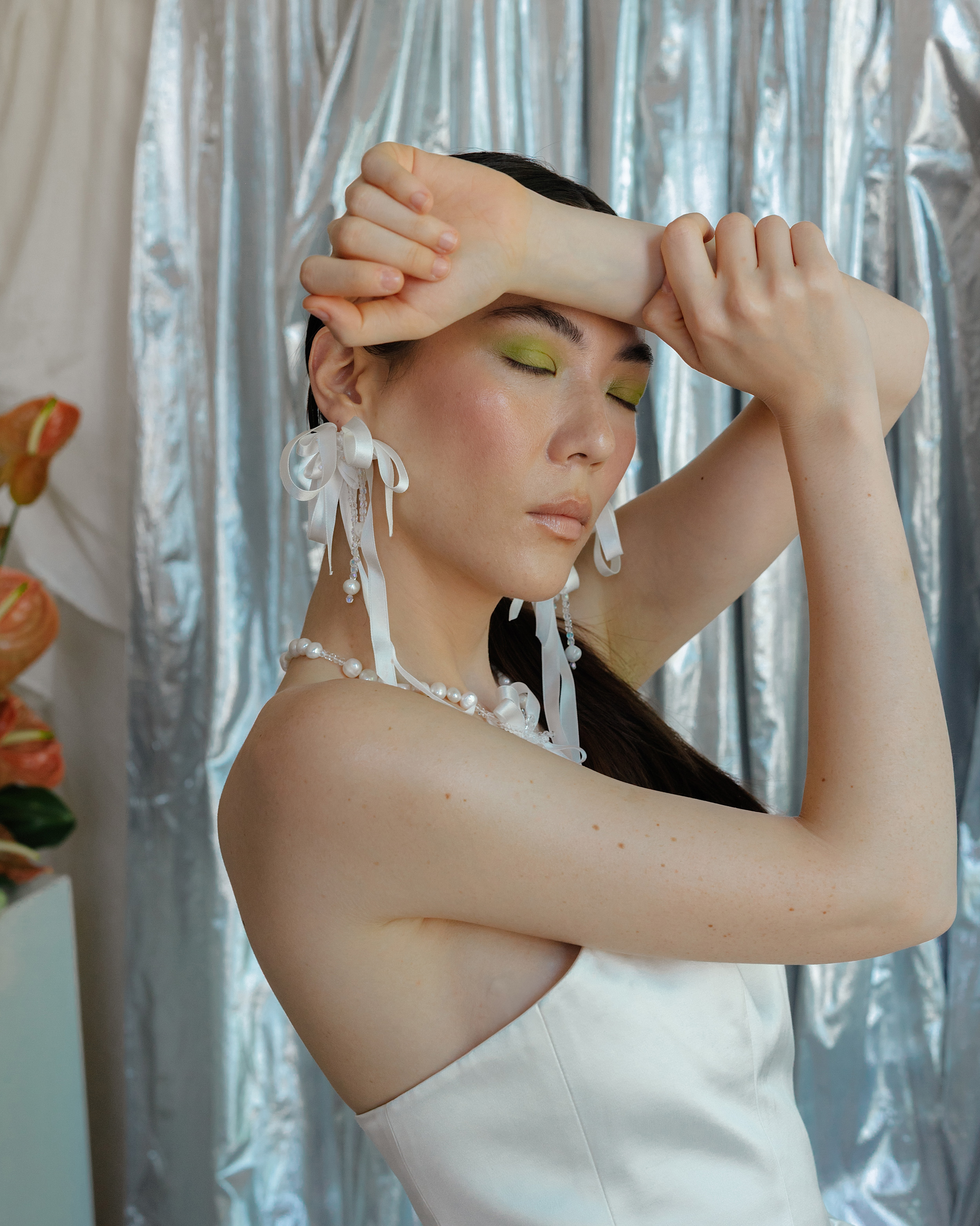 RLE Bride Studio Casso 089 - A Contemporary East Asian Inspired Bridal Fashion Editorial, Featuring RLE Bride Modern bride wearing RLE bride. She wears ribbon earrings and has her hair tied in a pony tail. Wolf & Co Photography.
