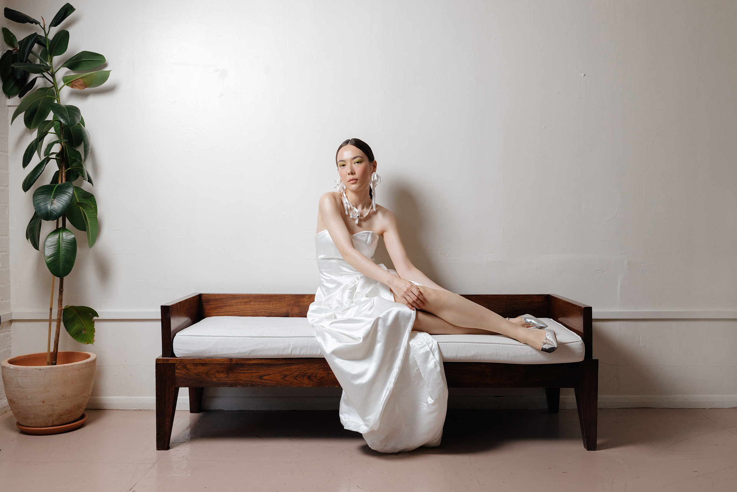 RLE Bride Studio Casso 119 - A Contemporary East Asian Inspired Bridal Fashion Editorial, Featuring RLE Bride Modern bride wearing RLE bride. She wears ribbon earrings and has her hair tied in a pony tail. Wolf & Co Photography.