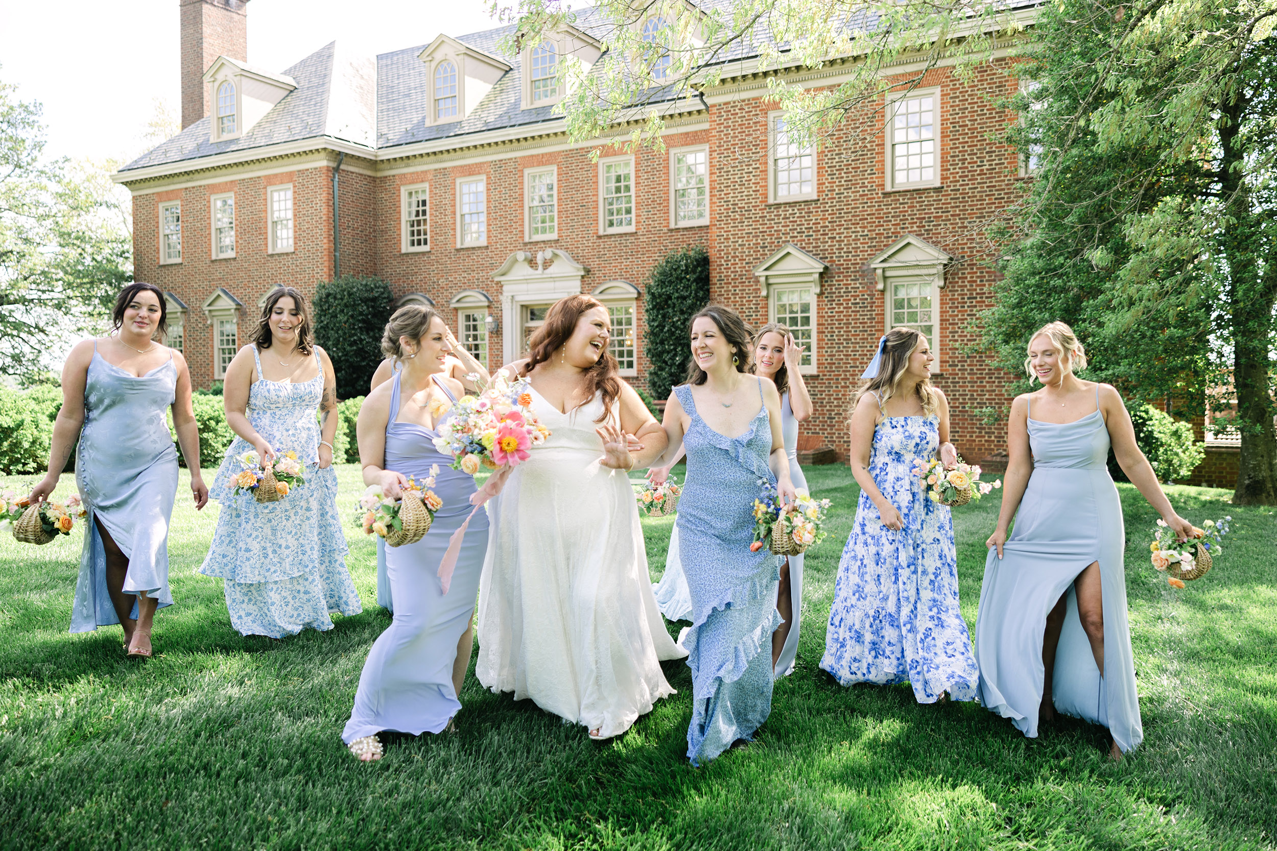 Bride frolicking with her bridesmaids who wear pale blue dressees. Spring wedding in Vancouver USA.