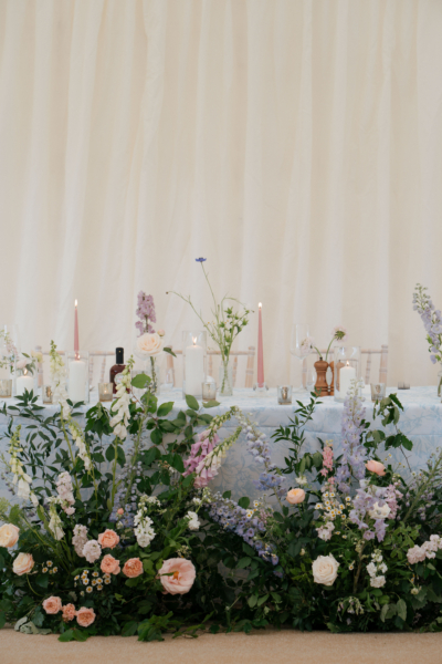 Marquee wedding with Floral meadow and patterned tablecloth a