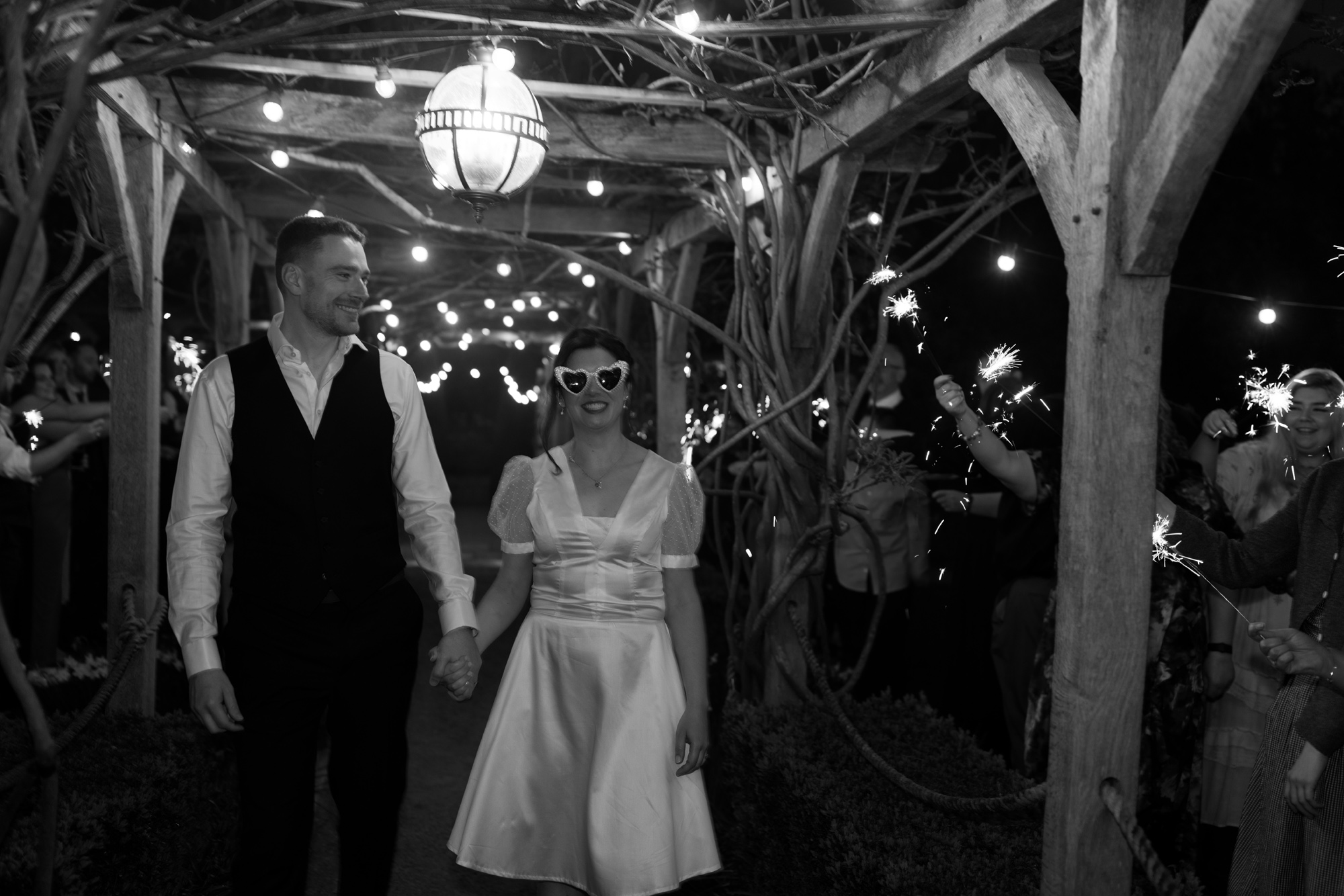 Bride wearing sunglasses at night time on her wedding day at Tythe.