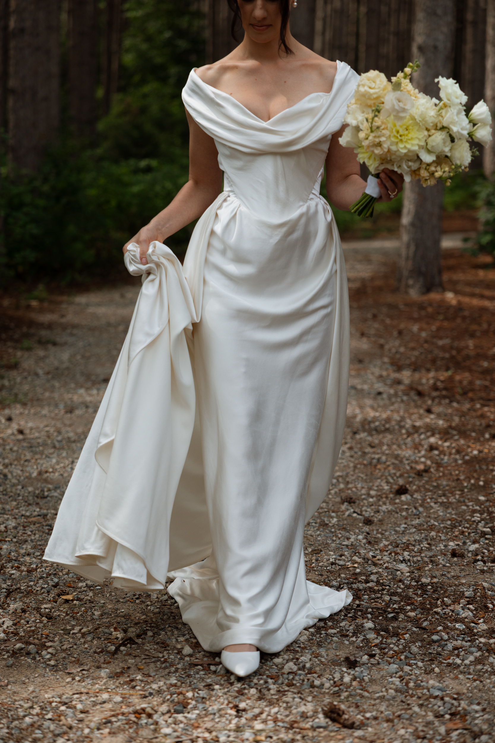 Vivienne Westwood wedding dress. Bride carries a yellow wedding bouquet.