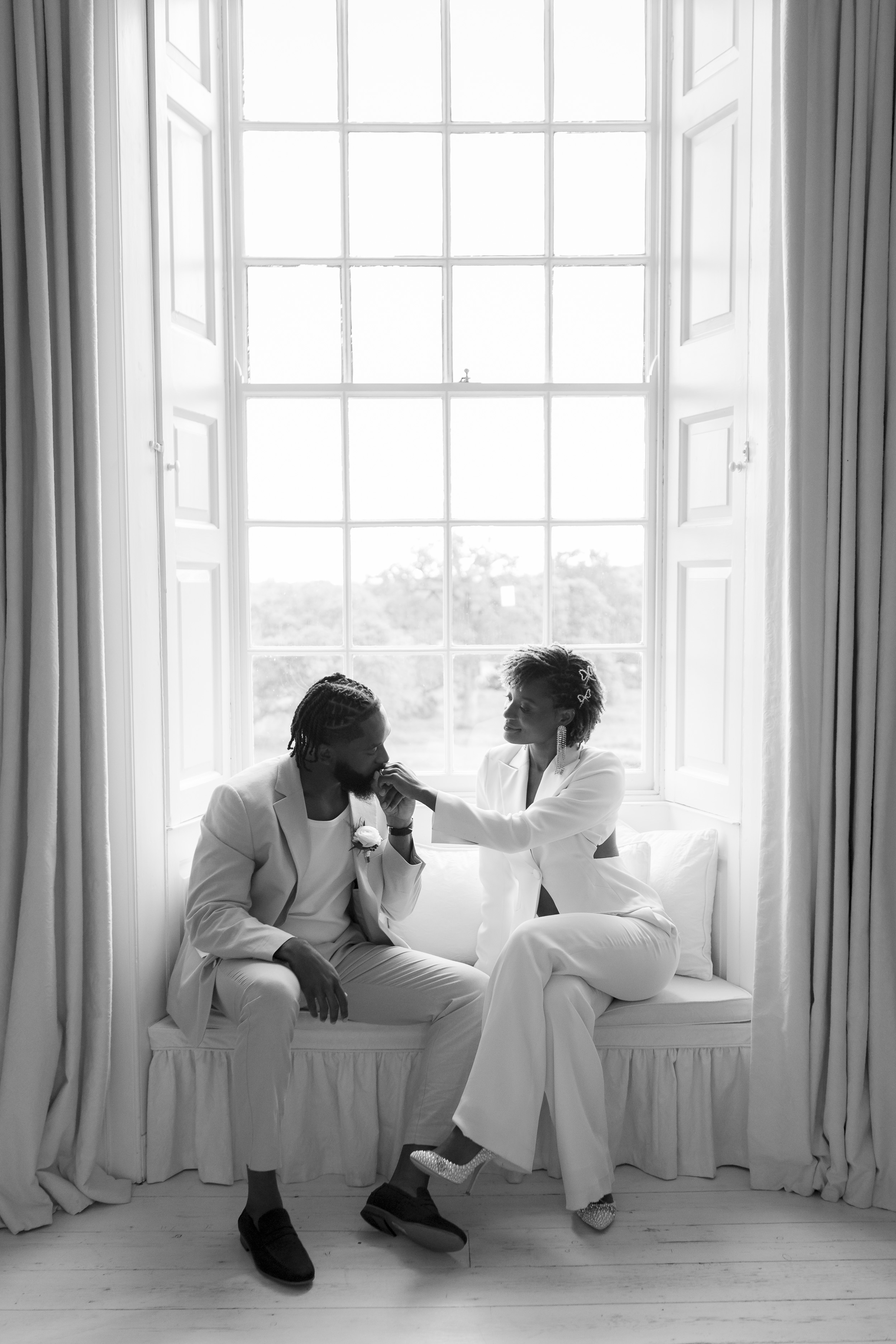 Wedding Presence Over Performance. Black Bride in a ailored suit and Black Groom sharing a meaingful and intimate moment.