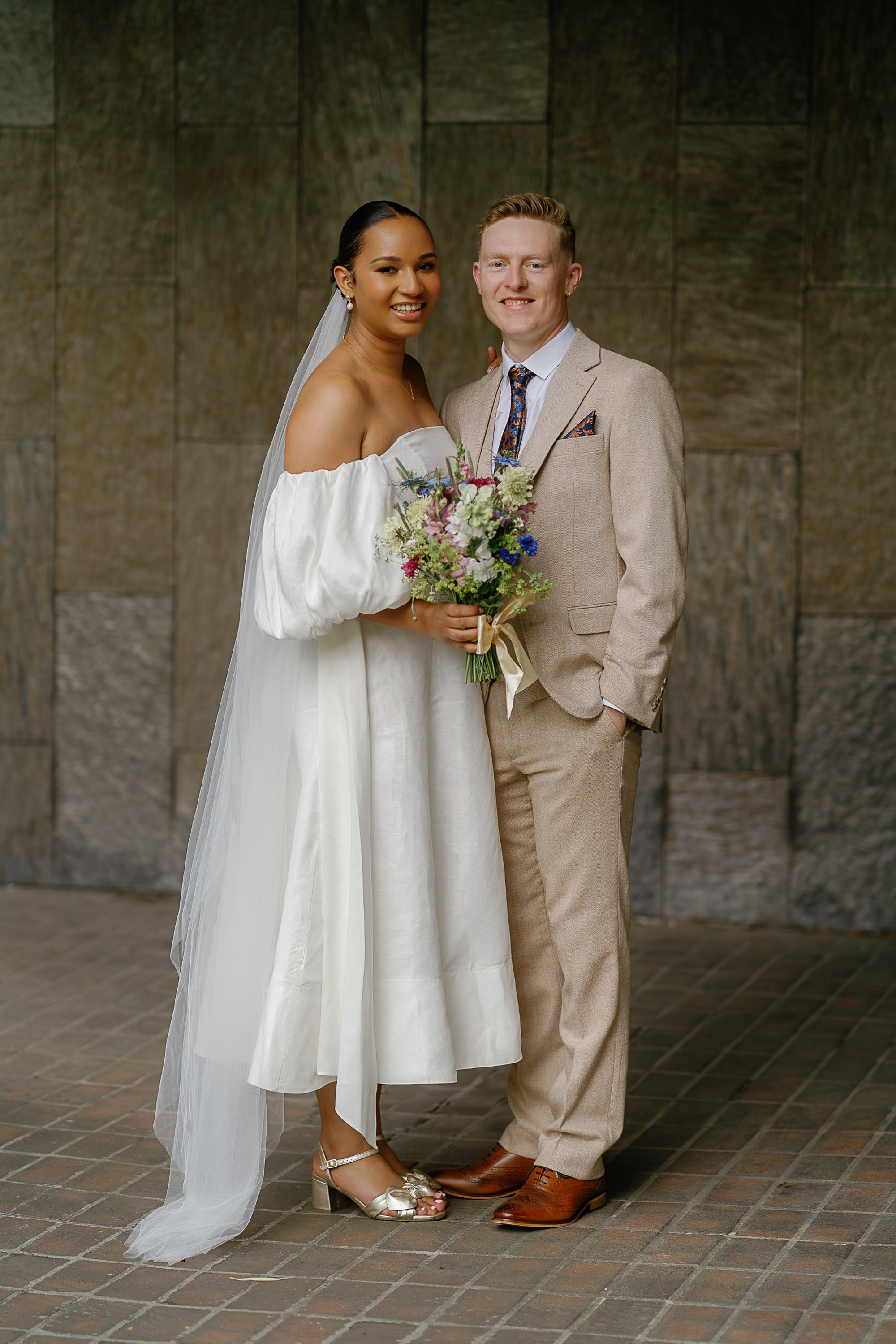Amy & Tom's Stripped Back & Fun Tyne Bank Brewery Wedding 10 Tyne Bank Brewery wedding in Newcastle upon Tyne. The bride wears an Aje dress with gold block heel shoes & bow, and a veil by Britten, via Vinted. The groom wears a sand colour suit & brown shoes. Silverbird Wedding Photography.