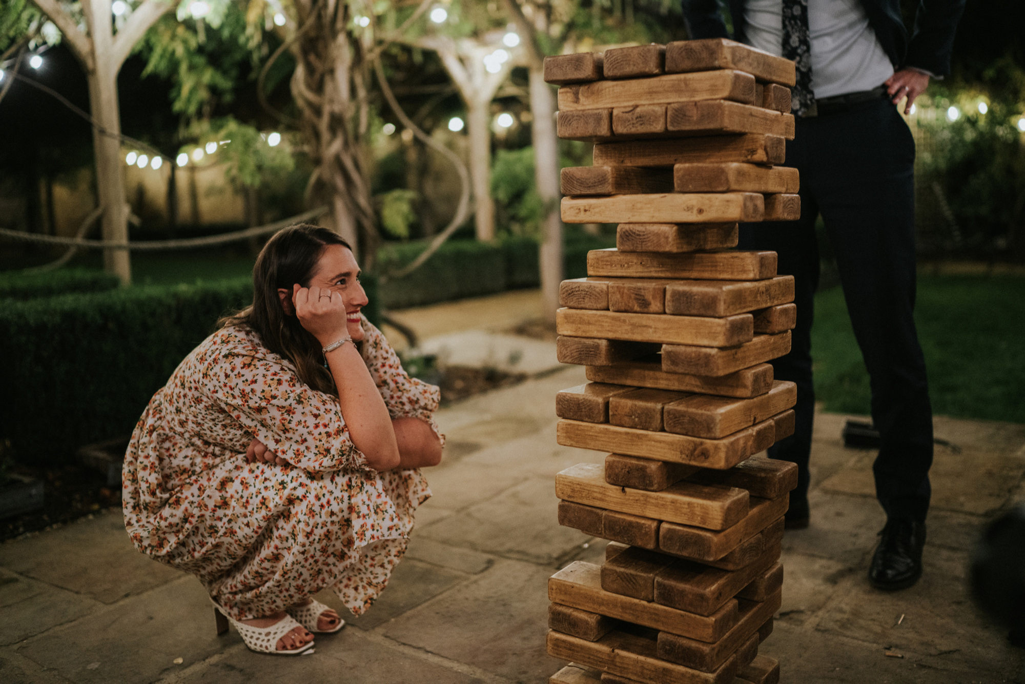 The New Wedding Aesthetic: A Sense of Home 23 Wedding guest playing giant Jenga at Tythe, Oxfordshire barn wedding venue.