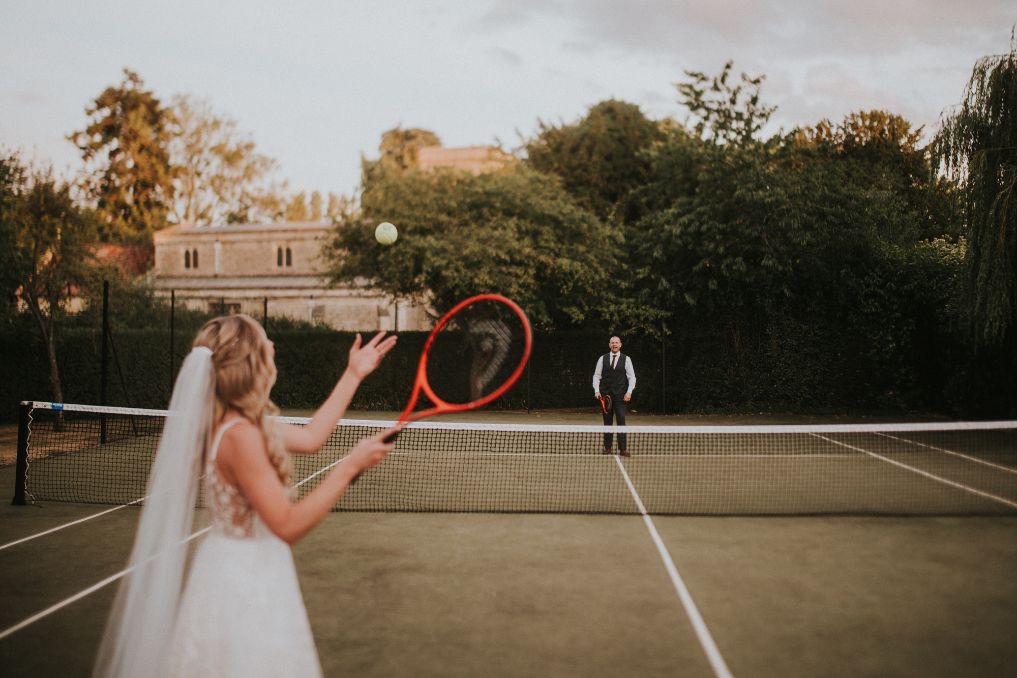 The New Wedding Aesthetic: A Sense of Home 22 Bride playing tennis at Tythe, Oxfordshire barn wedding venue.