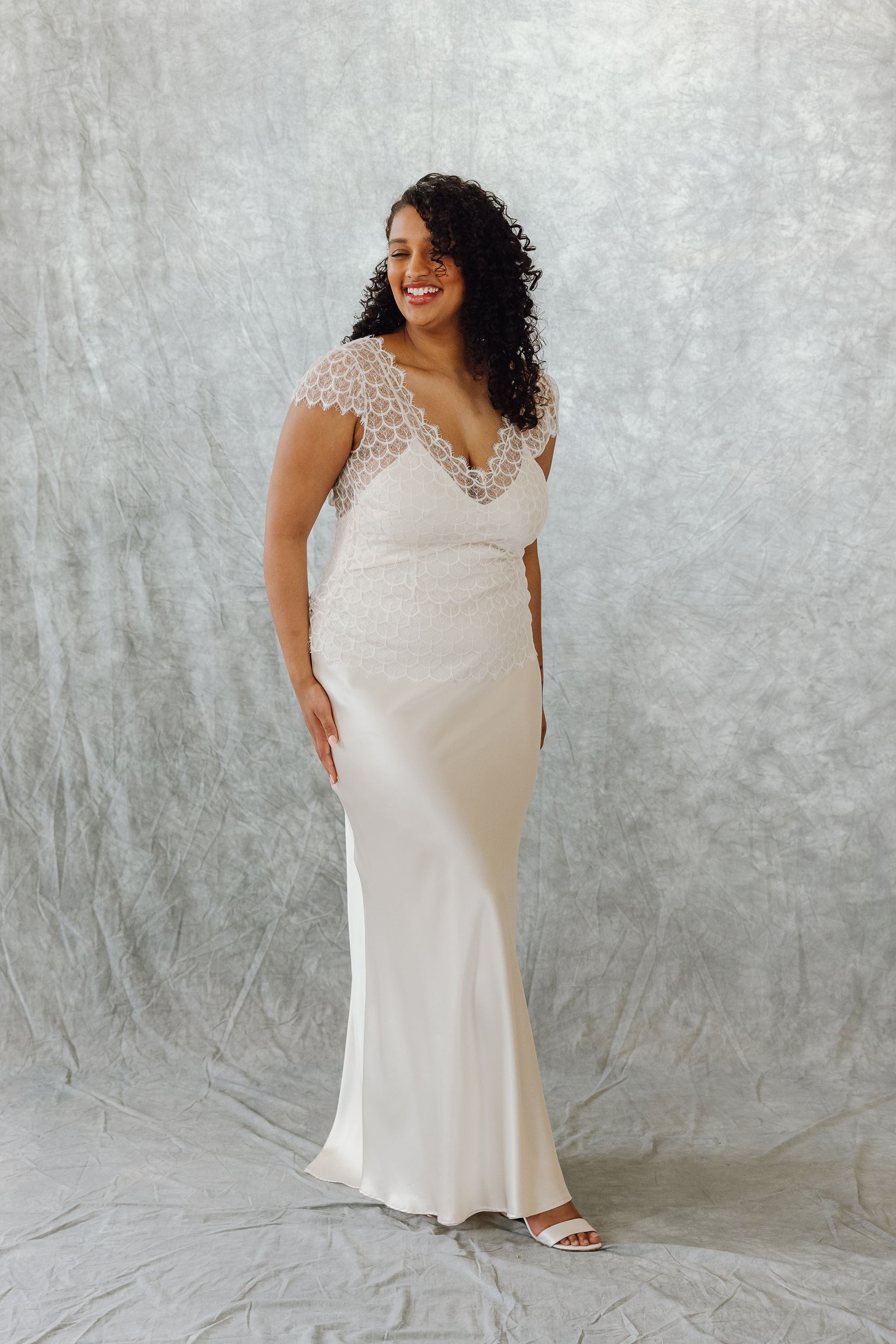 Astilbe lace top silk slip wedding dress bridal separates KateBeaumont Icons 1 IndiaHobson HR 424 - Kate Beaumont: Lovingly Handmade Silk Wedding Dresses Black curvy model bride with loose curly air wearing a silk and lace wedding dress by Kate Beaumont.