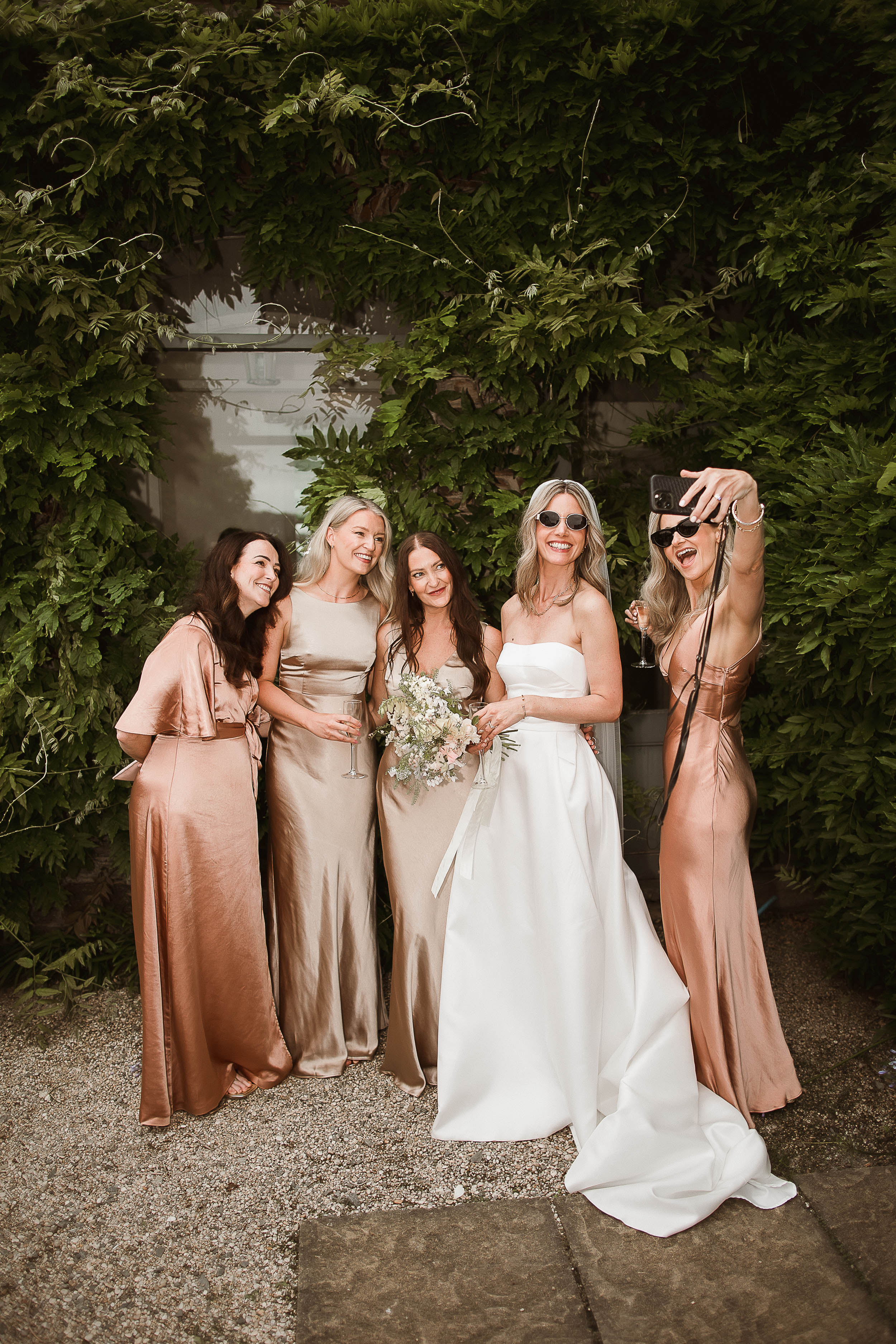 Boconnoc Estate Wedding Cornwall Jesus Peiro 108 1 - Lauren in Jesus Peiro for her Elegant Boconnoc Estate Wedding in Cornwall Bride posing for a selfie with her bridesmaids. She wears a Jesus Peiro dress and they were copper and gold colour Six Stories dresses.