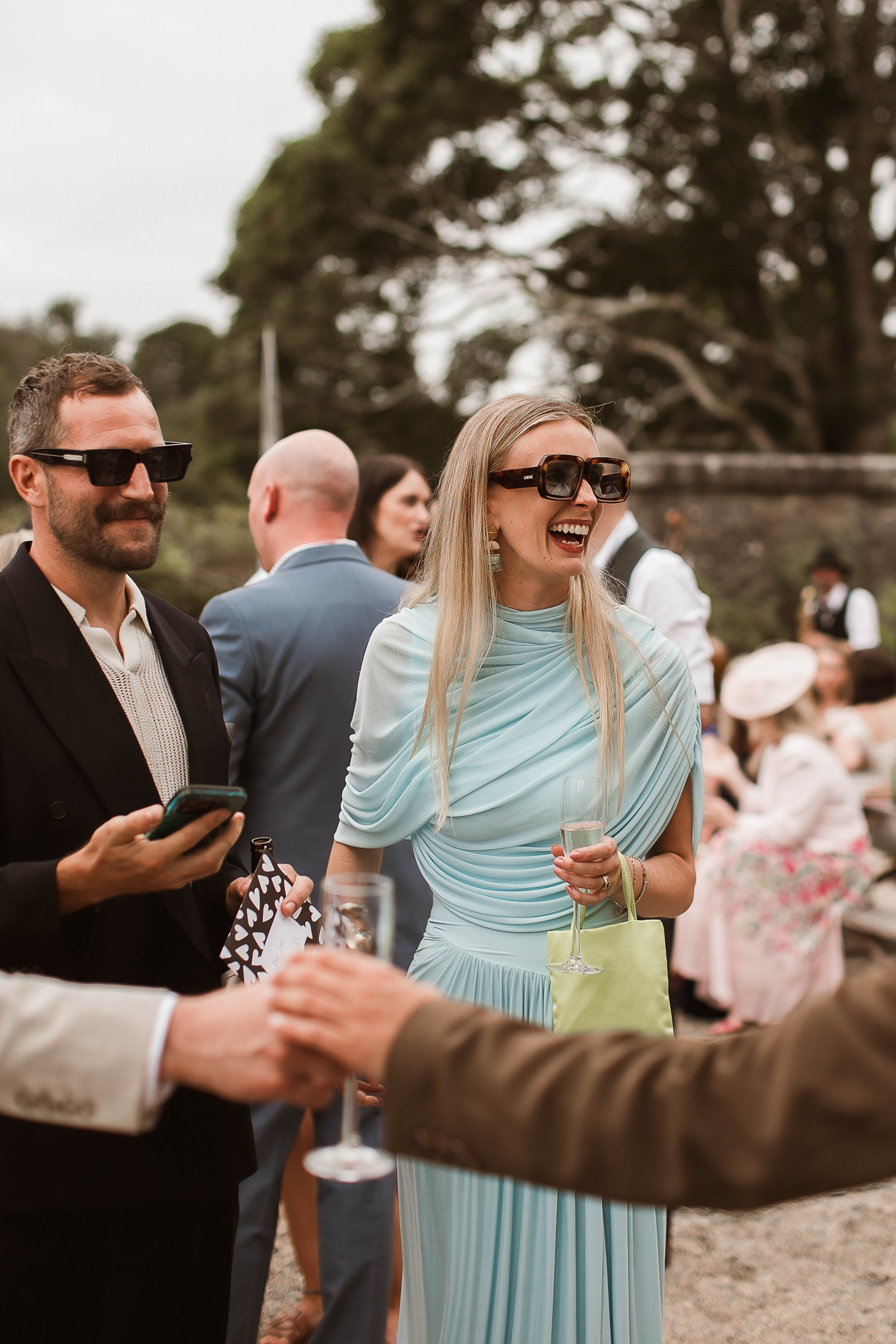Boconnoc Estate Wedding Cornwall Jesus Peiro 112 - Lauren in Jesus Peiro for her Elegant Boconnoc Estate Wedding in Cornwall Wedding guest in a pale blue dress wnd large sunglasses.