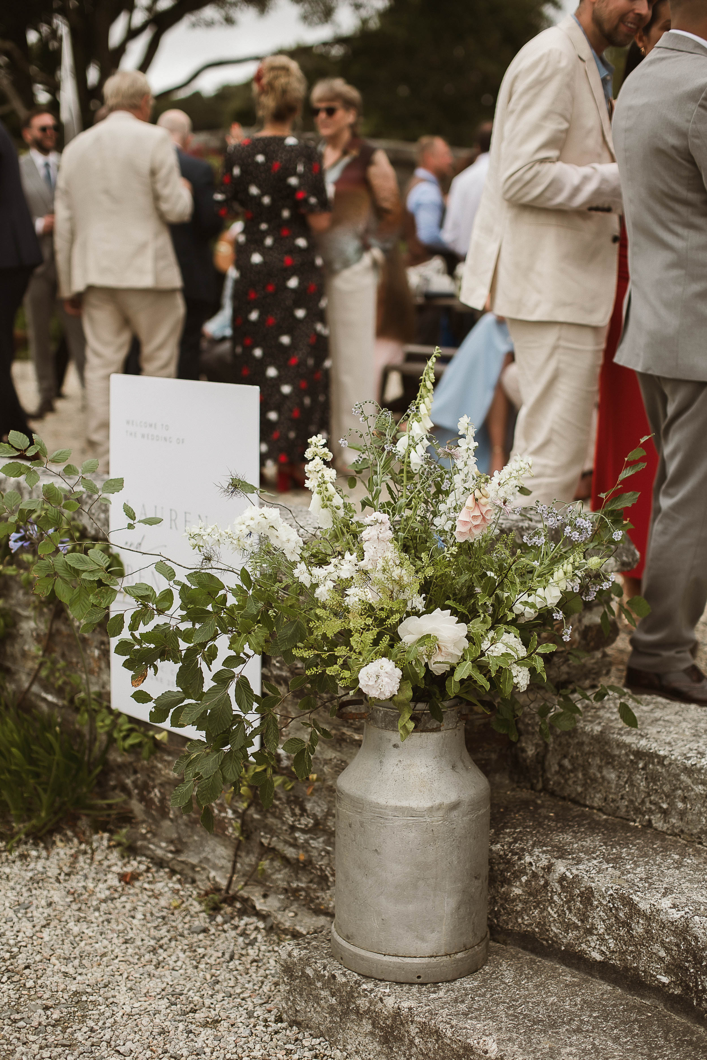 Boconnoc Estate Wedding Cornwall Jesus Peiro 116 1 - Lauren in Jesus Peiro for her Elegant Boconnoc Estate Wedding in Cornwall Milk churn filled with pastel colour wedding flowers including pale pink Foxgloves.