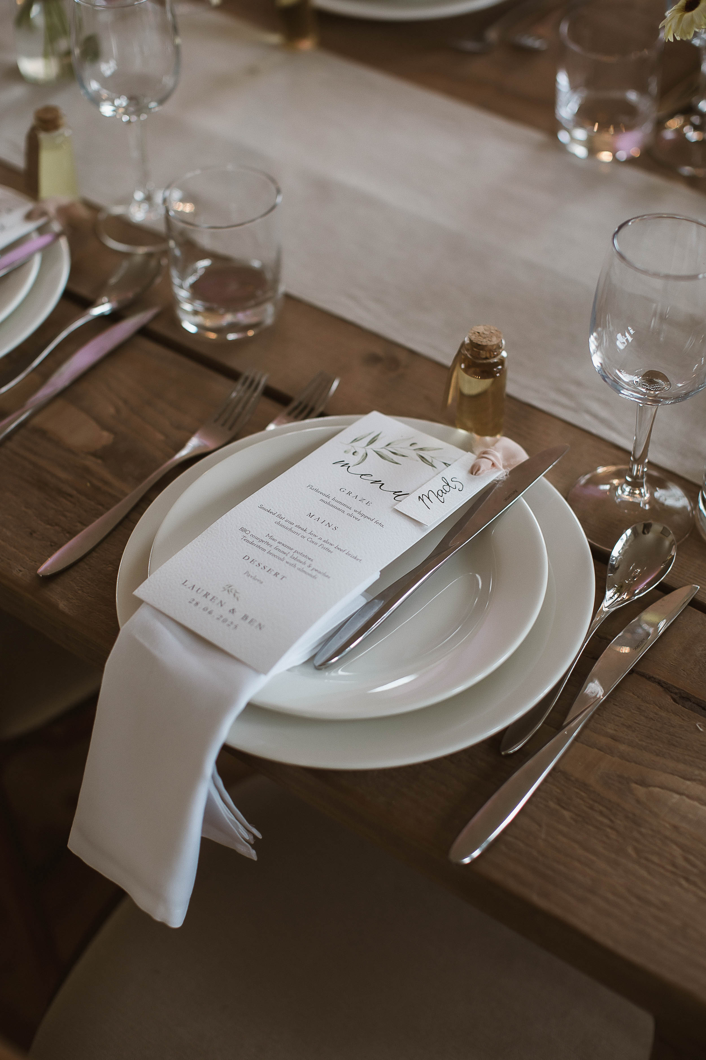 Boconnoc Estate Wedding Cornwall Jesus Peiro 118 1 - Lauren in Jesus Peiro for her Elegant Boconnoc Estate Wedding in Cornwall Elegant wedding table decor with taper candles in brown and green with a natural colour linen table runner, simple bud vases, natural colour tableware and printed menus.