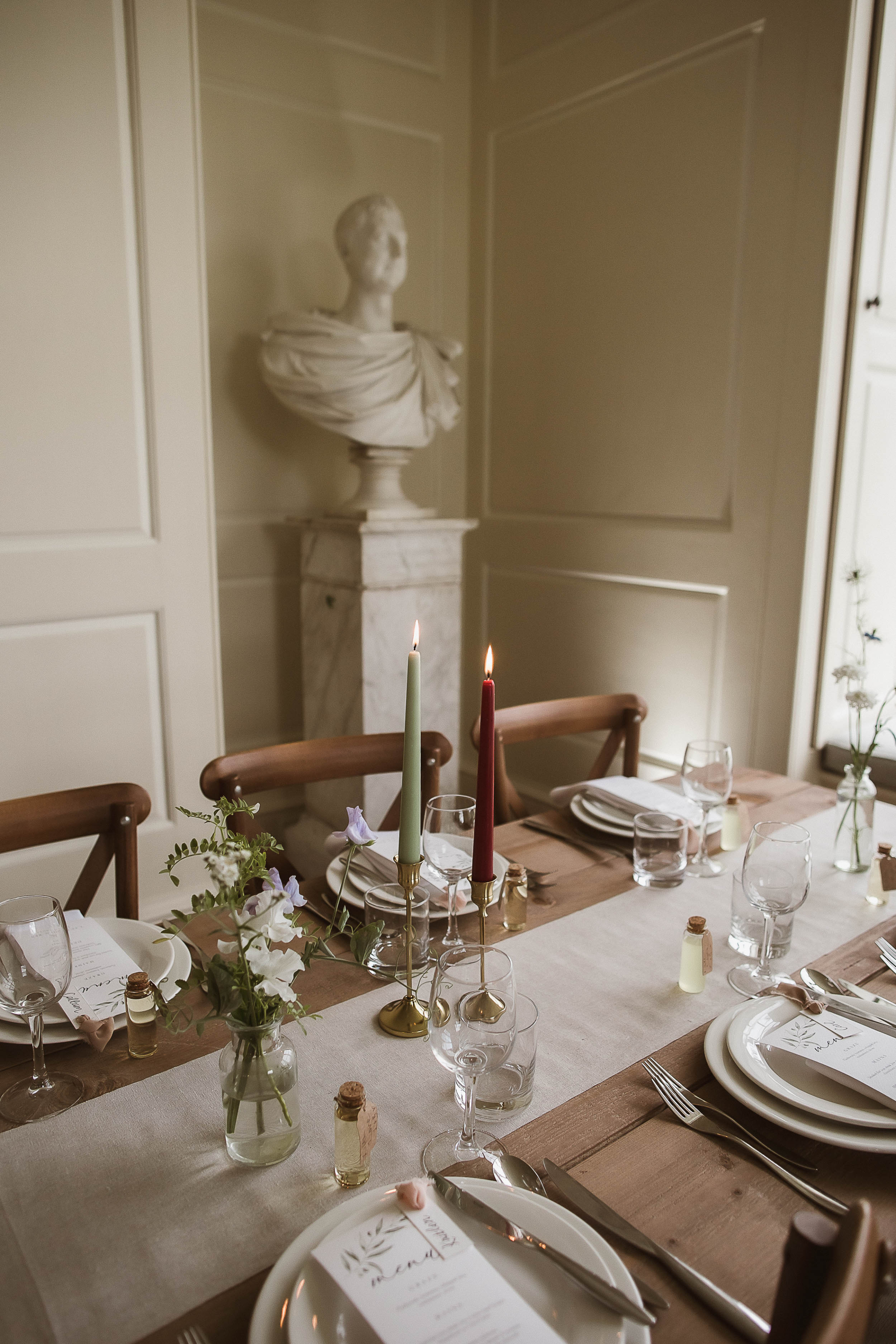 Boconnoc Estate Wedding Cornwall Jesus Peiro 125 - Lauren in Jesus Peiro for her Elegant Boconnoc Estate Wedding in Cornwall Elegant wedding table decor with taper candles in brown and green with a natural colour linen table runner, simple bud vases, natural colour tableware and printed menus.