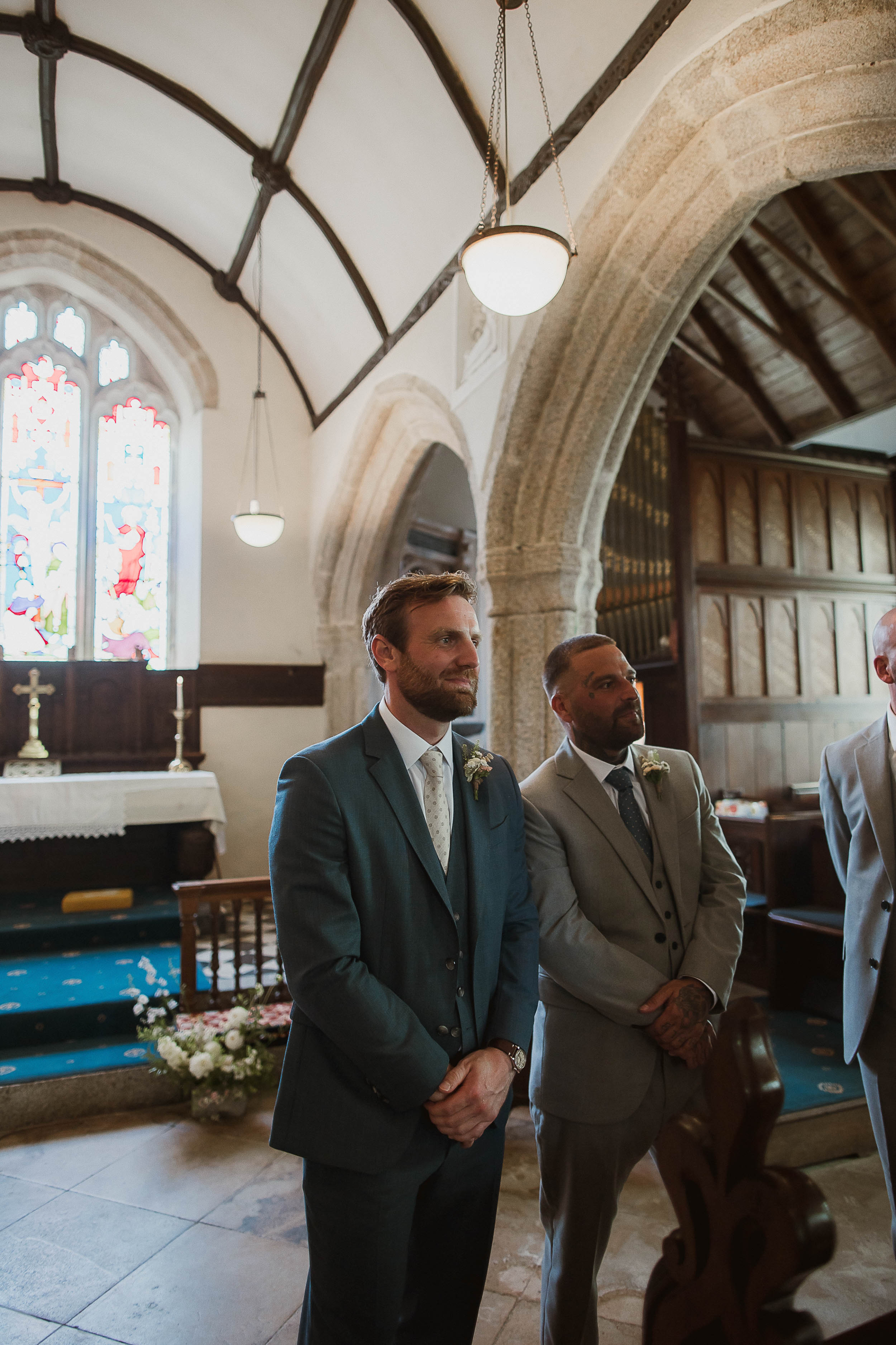 Boconnoc Estate Wedding Cornwall Jesus Peiro 60 - Lauren in Jesus Peiro for her Elegant Boconnoc Estate Wedding in Cornwall Groom wearing a Hugo Boss wedding suit eagerly awaiting the arrival of his bride in the church.