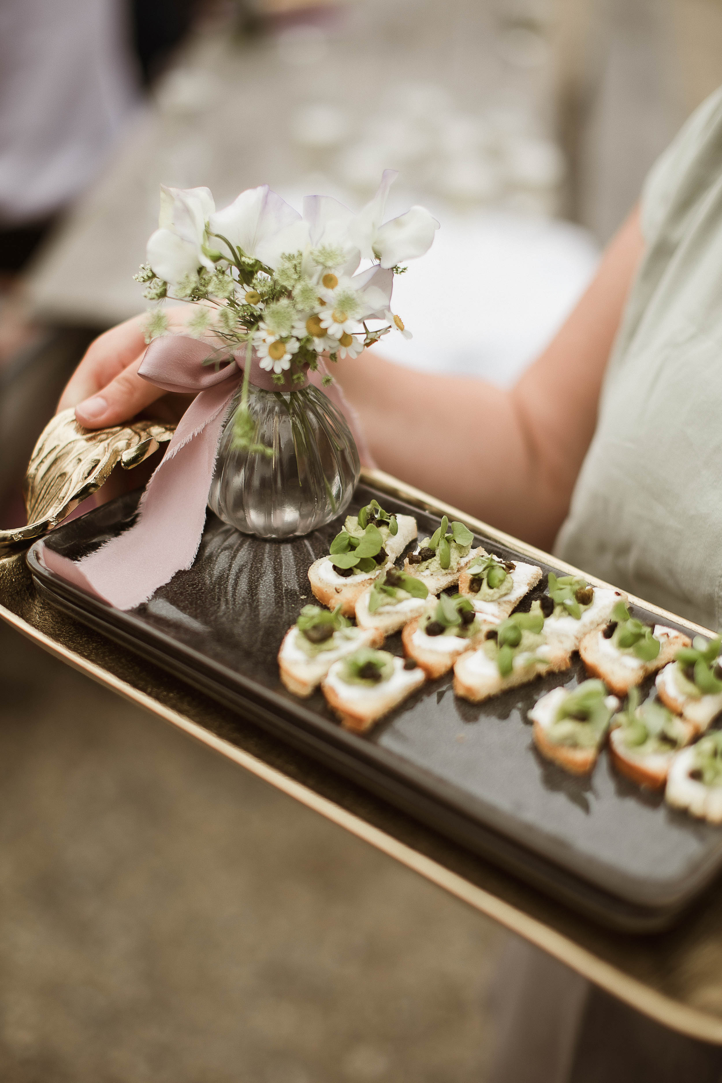 Boconnoc Estate Wedding Cornwall Jesus Peiro 99 - Lauren in Jesus Peiro for her Elegant Boconnoc Estate Wedding in Cornwall Closeup shot of wedding canapes being served on a tray with a tiny bud vase filled with Feverfew.
