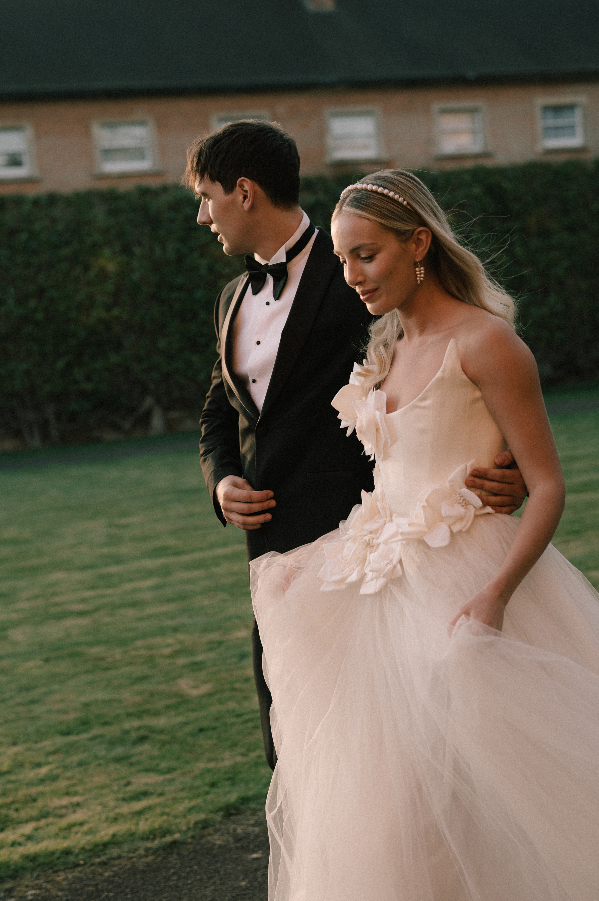 Earnshill House Wedding Editorial Fern Godfrey Weddings 17 - Modern Bridal Elegance at Earnshill House, A Romantic Somerset Wedding Venue Groom in black tie and bride in a JULITA dres with 3D silk roses wandering the gardens at Earnshill House, a romantic Somerset county house wedding venue.