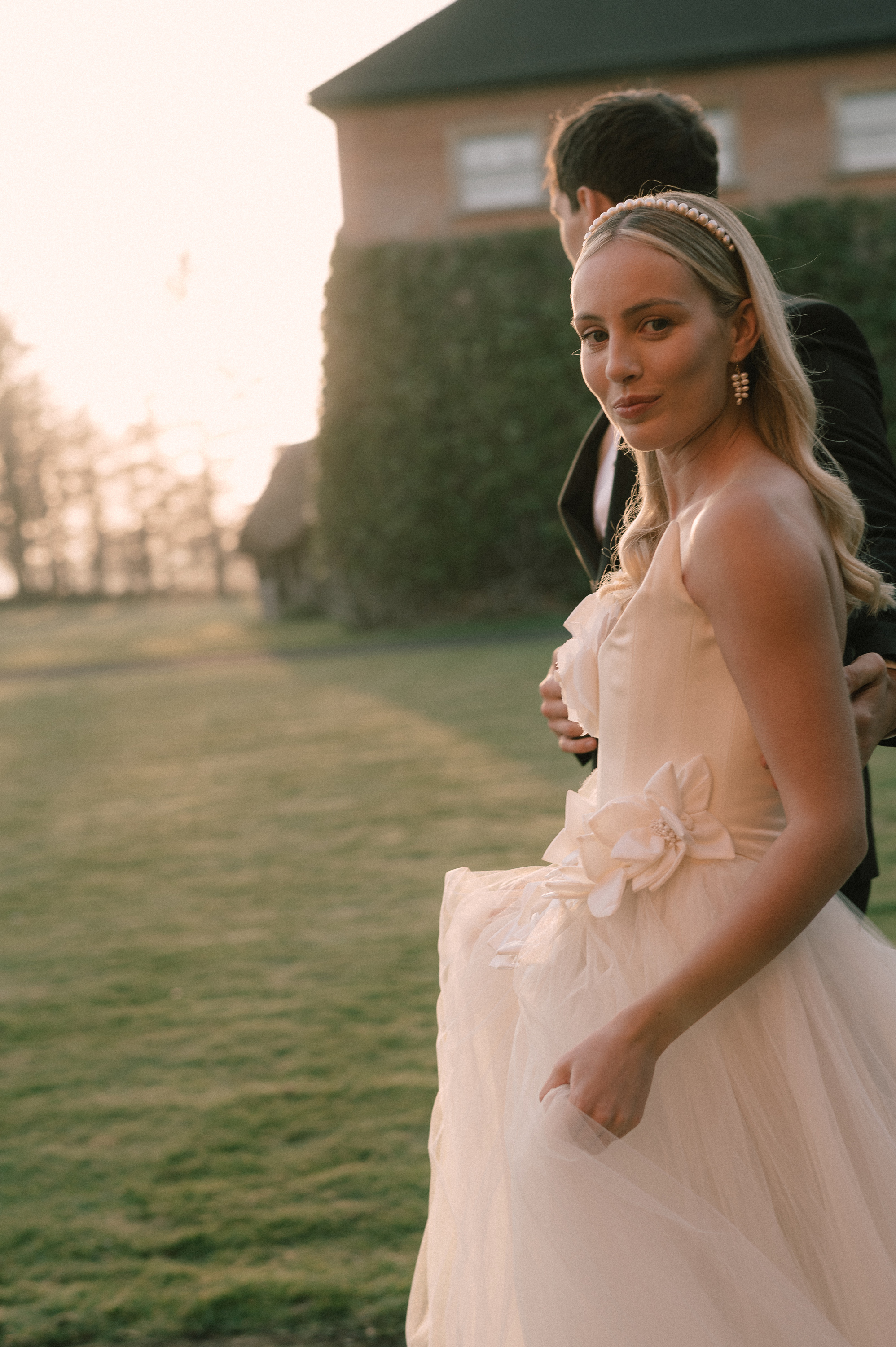 Earnshill House Wedding Editorial Fern Godfrey Weddings 18 - Modern Bridal Elegance at Earnshill House, A Romantic Somerset Wedding Venue Groom in black tie and bride in a JULITA dres with 3D silk roses wandering the gardens at Earnshill House, a romantic Somerset county house wedding venue.