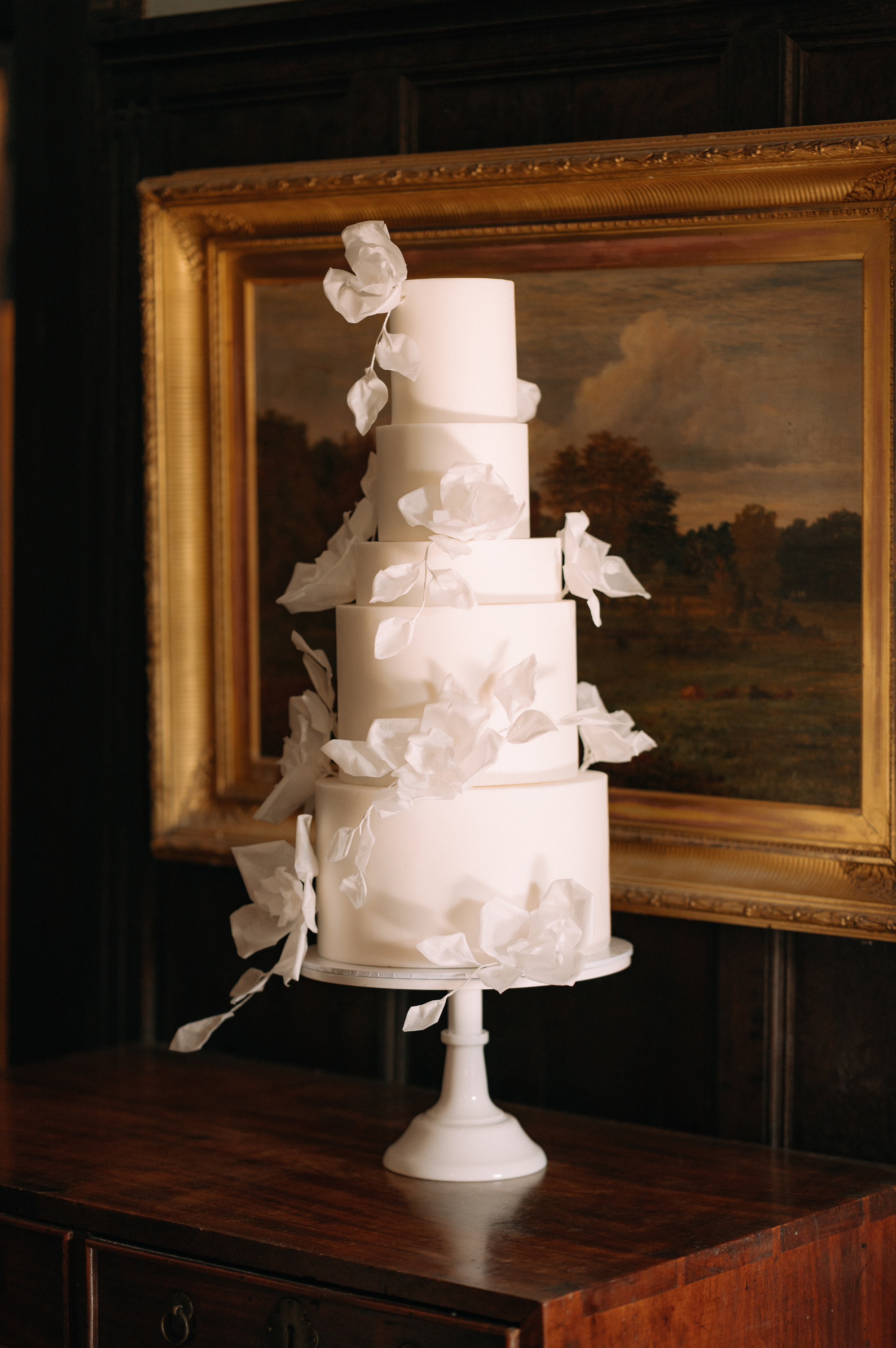 Earnshill House Wedding Editorial Fern Godfrey Weddings 2 - Modern Bridal Elegance at Earnshill House, A Romantic Somerset Wedding Venue 5 tier white wedding cake with sculpted flowers. Earnshill House, a romantic Somerset county house wedding venue.