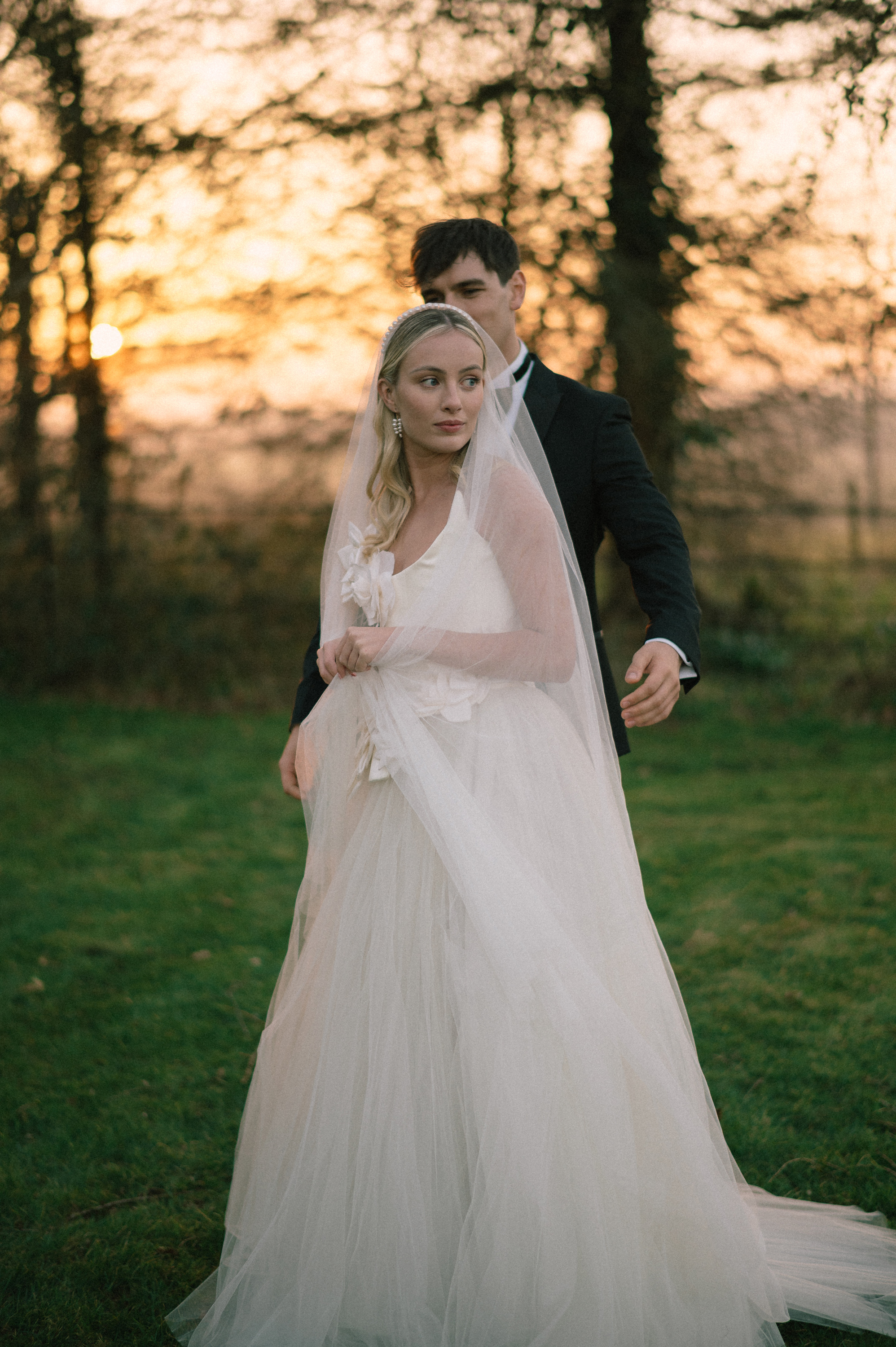Earnshill House Wedding Editorial Fern Godfrey Weddings 31 - Modern Bridal Elegance at Earnshill House, A Romantic Somerset Wedding Venue Groom in black tie and bride in a JULITA dres with 3D silk roses wandering the gardens at Earnshill House, a romantic Somerset county house wedding venue.