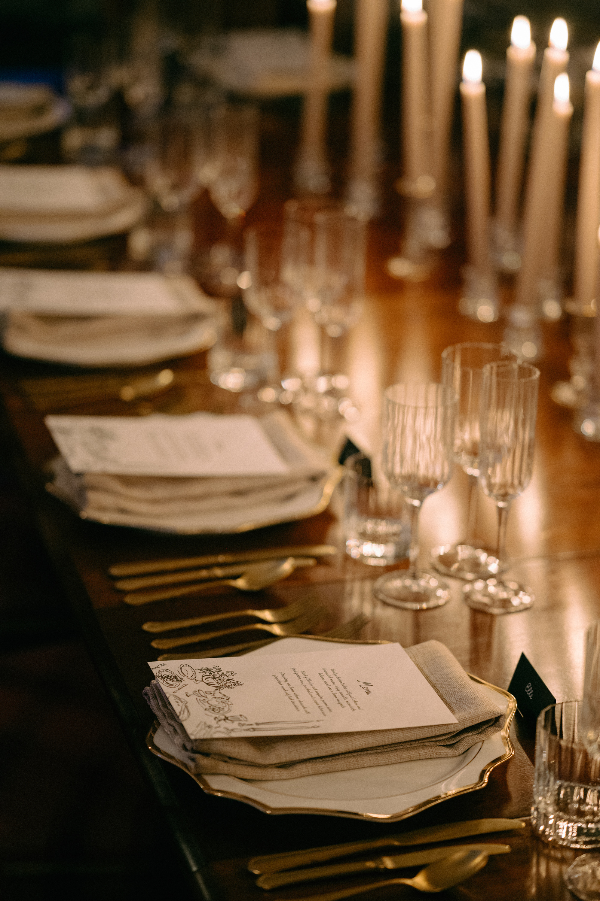 Earnshill House Wedding Editorial Fern Godfrey Weddings 50 - Modern Bridal Elegance at Earnshill House, A Romantic Somerset Wedding Venue Elegant minimalist wedding stationery sat upon cotton napkins on gold rimmed china plates.