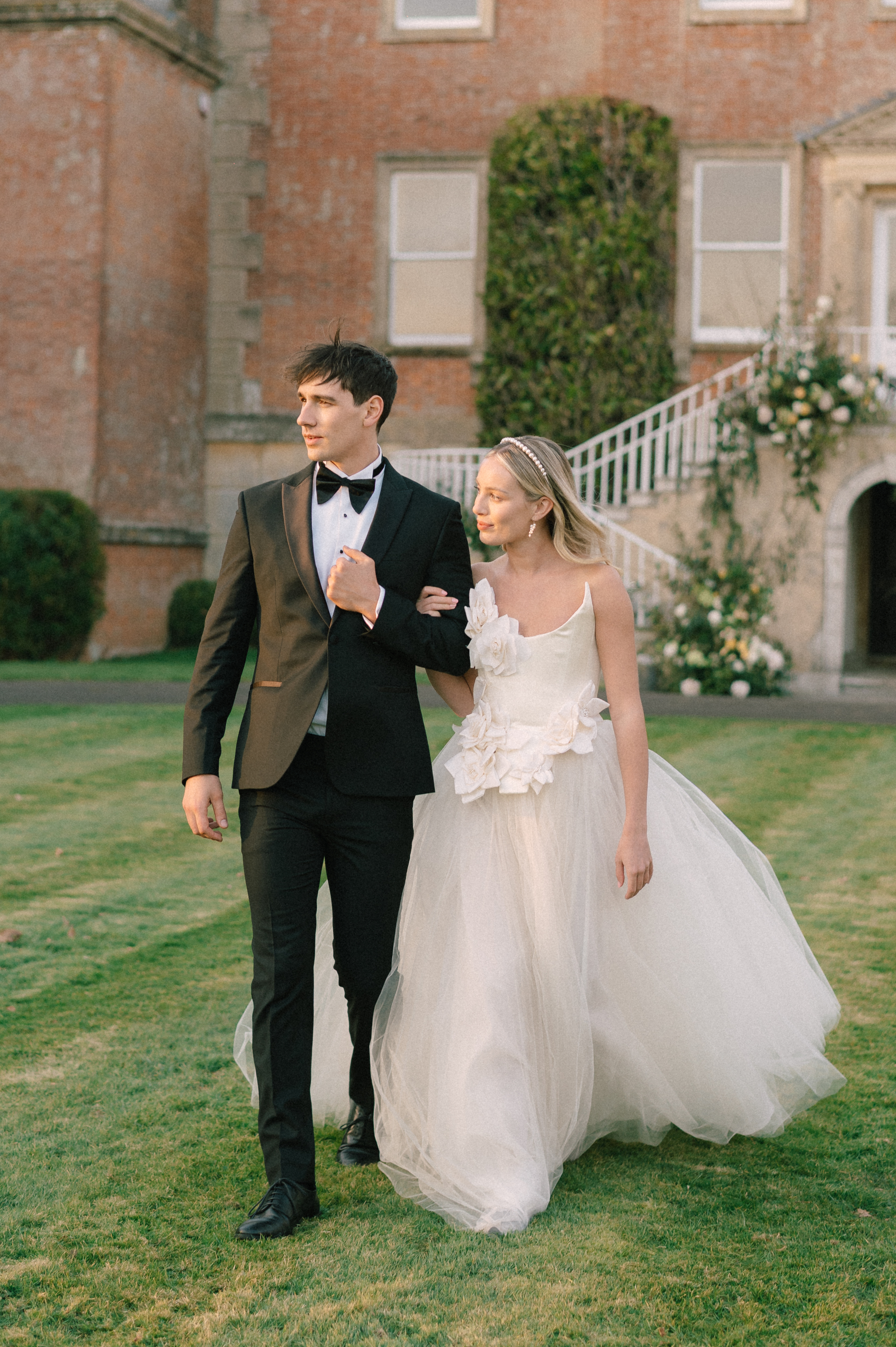 Earnshill436 - Modern Bridal Elegance at Earnshill House, A Romantic Somerset Wedding Venue Groom in black tie and bride wearing a JULITA corseted tulle wedding dress with 3D silk roses. Earnshill House, A romantic Somerset county house wedding venue.