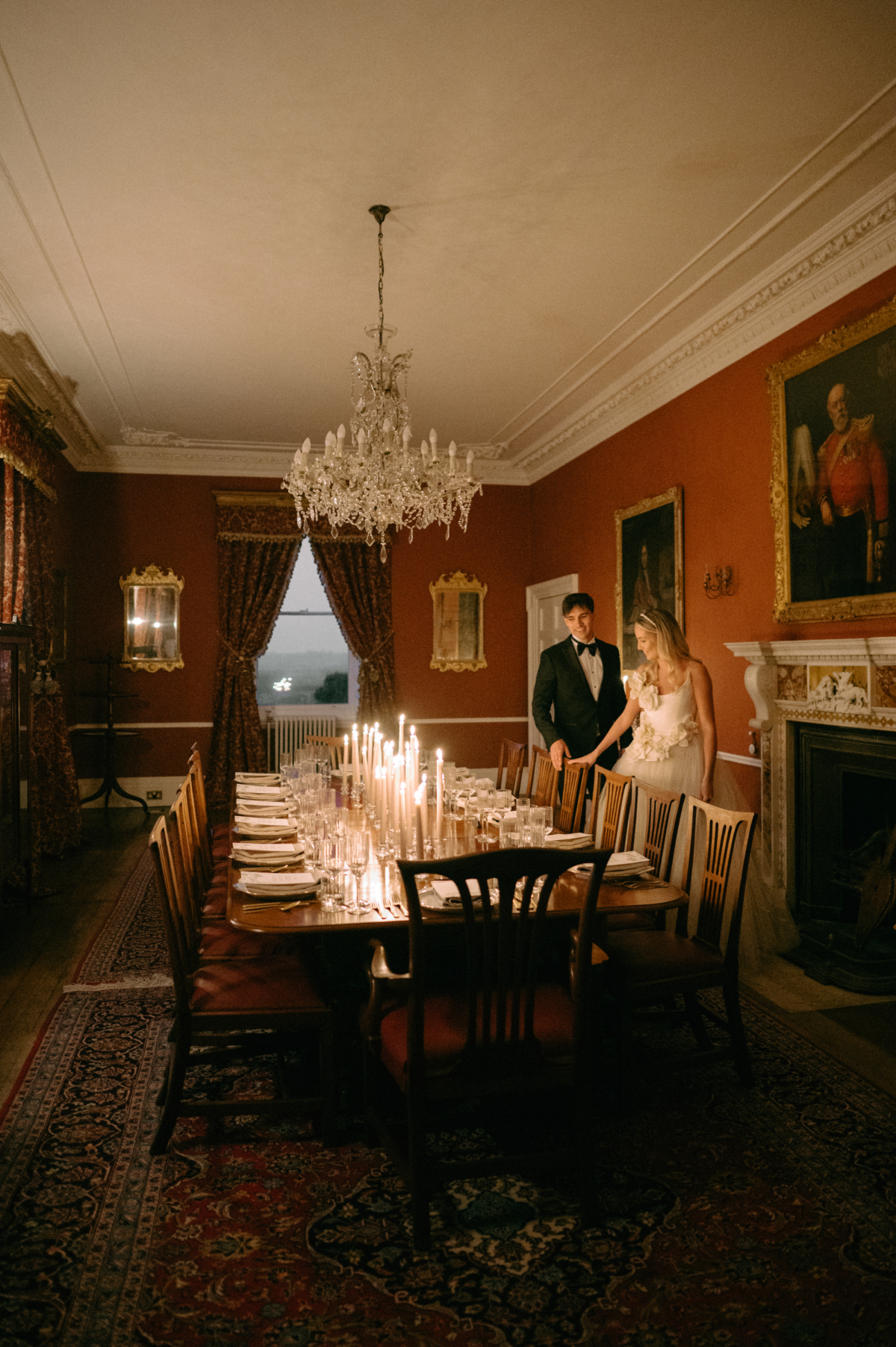 Earnshill576 - Modern Bridal Elegance at Earnshill House, A Romantic Somerset Wedding Venue Romantic candlelit wedding reception scene at Groom in black tie and bride in a JULITA dres with 3D silk roses wandering the gardens at Earnshill House, a romantic Somerset county house wedding venue. Tall white taper candles, ribbed glasses, gold cutlery and simple stationery keeps the scene minimalist but luxuriously elevated.