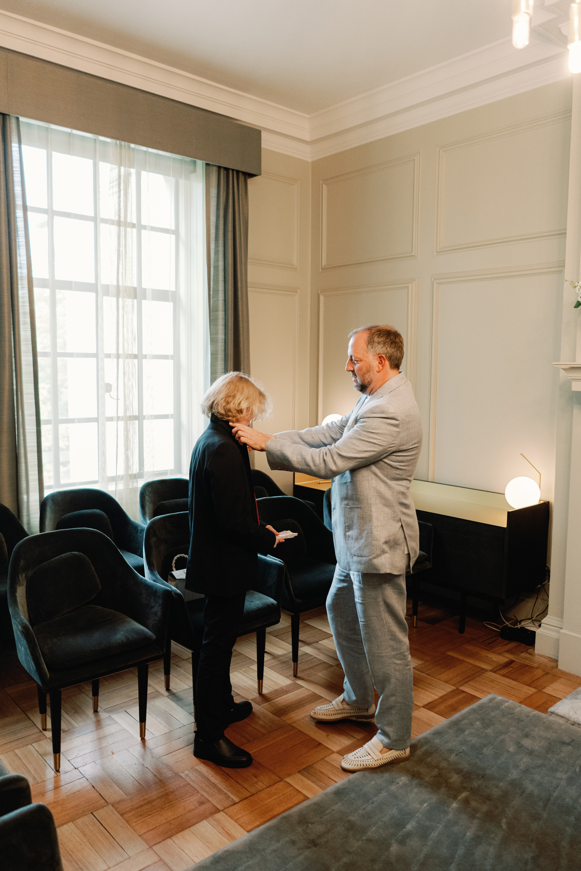 Emmylou Kelly Registry Office Wedding Jessica Lily Photography 101 - Photographer Emmylou Kelly & Paul's Intimate Family Registry Office Wedding Groom in pale blue suit with his son waiting for his bride to arrive at the registry office wedding ceremony.