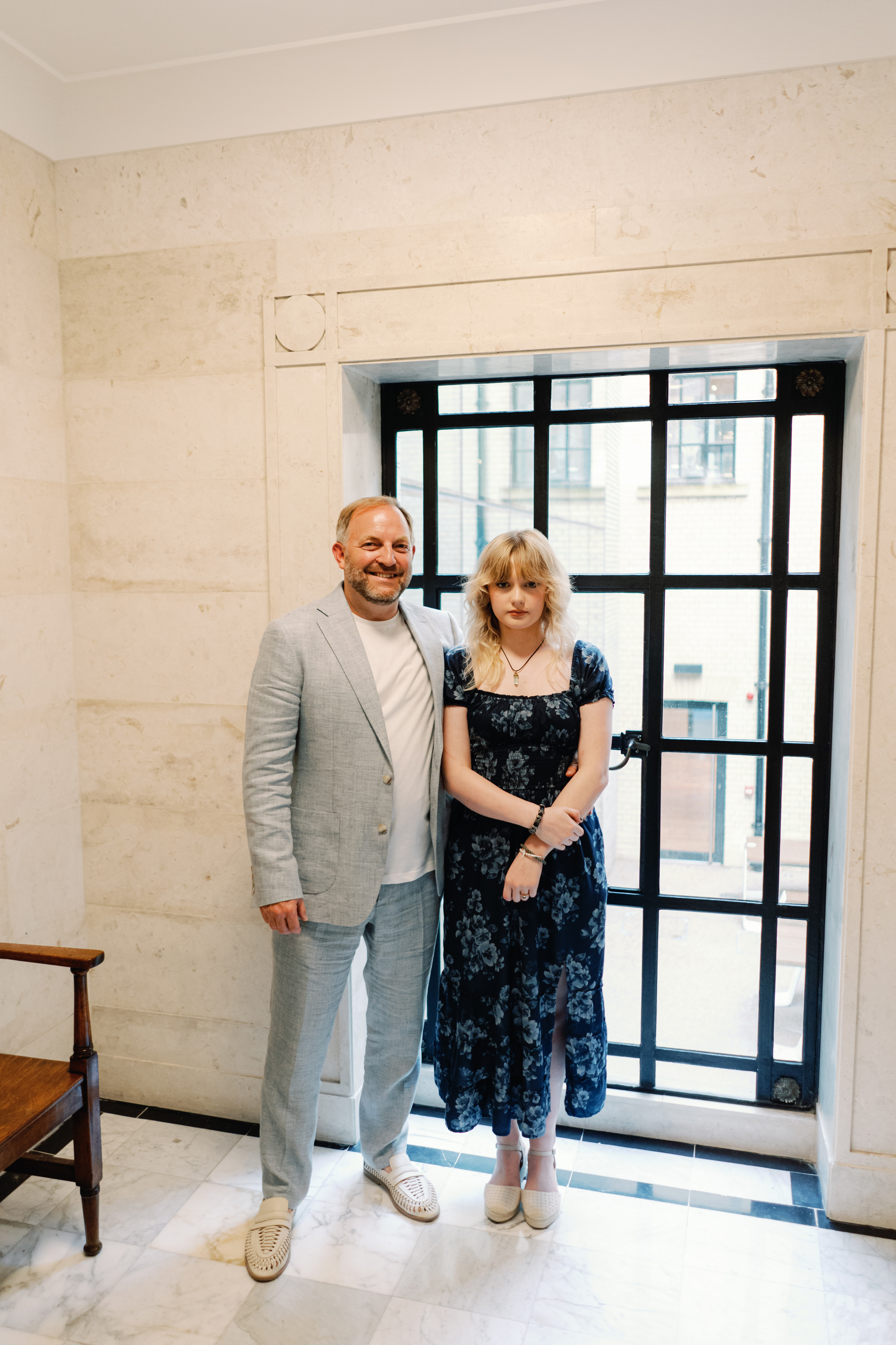 Emmylou Kelly Registry Office Wedding Jessica Lily Photography 115 - Photographer Emmylou Kelly & Paul's Intimate Family Registry Office Wedding Groom in pale blue suit standing with his daughter in a blue floral dress and espadrilles.