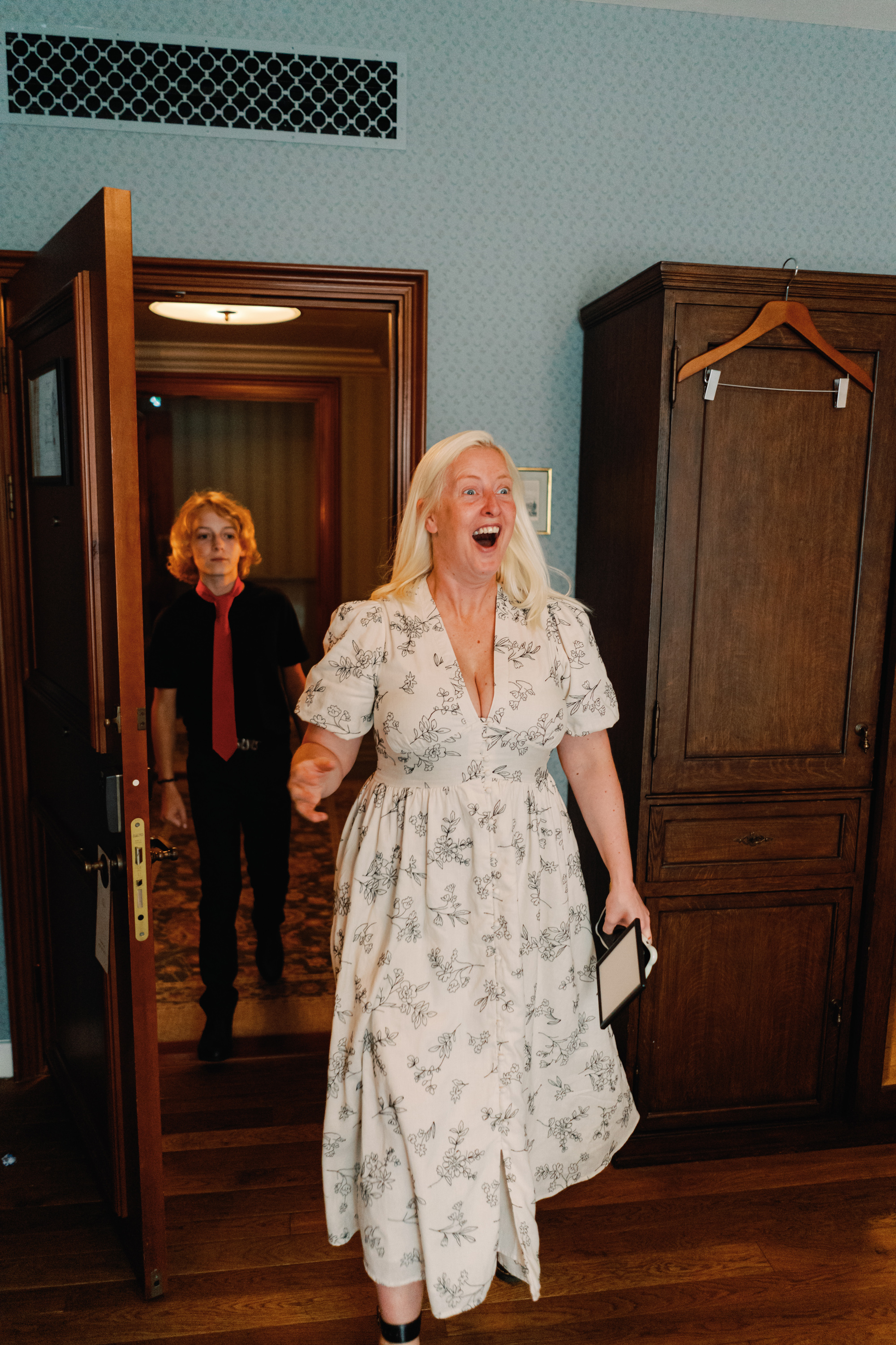 Emmylou Kelly Registry Office Wedding Jessica Lily Photography 86 - Photographer Emmylou Kelly & Paul's Intimate Family Registry Office Wedding Wedding guests in a floral dress enters the getting ready room.