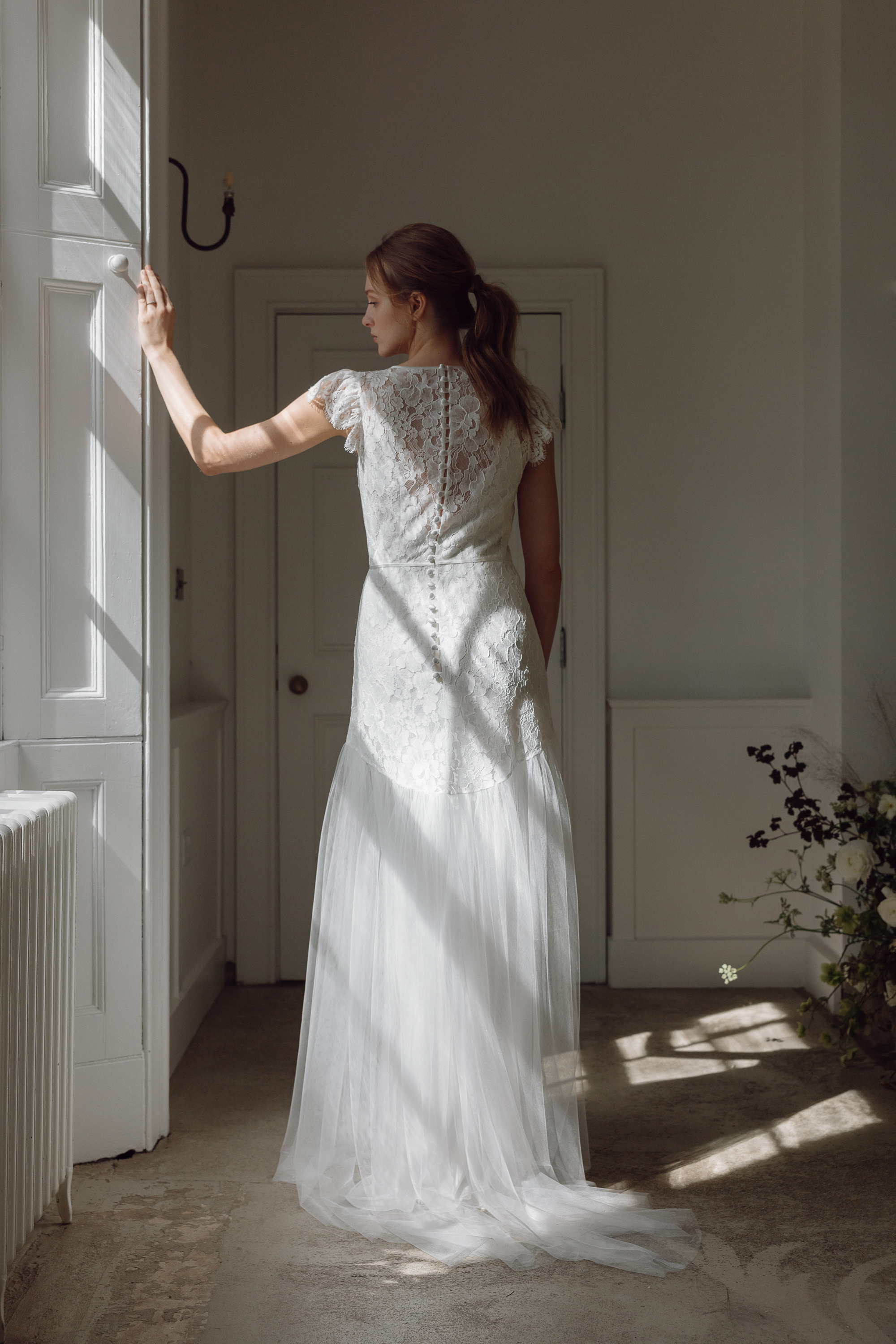 Elegant modern lace and tulle wedding dress by Kate Beaumont.