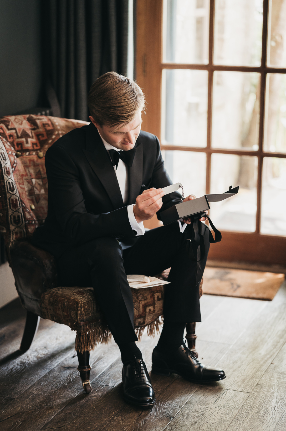 The New Wedding Aesthetic: A Sense of Home 34 Groom in black tie getting ready on the morning of his wedding at Tythe, Oxfordshire barn wedding venue.