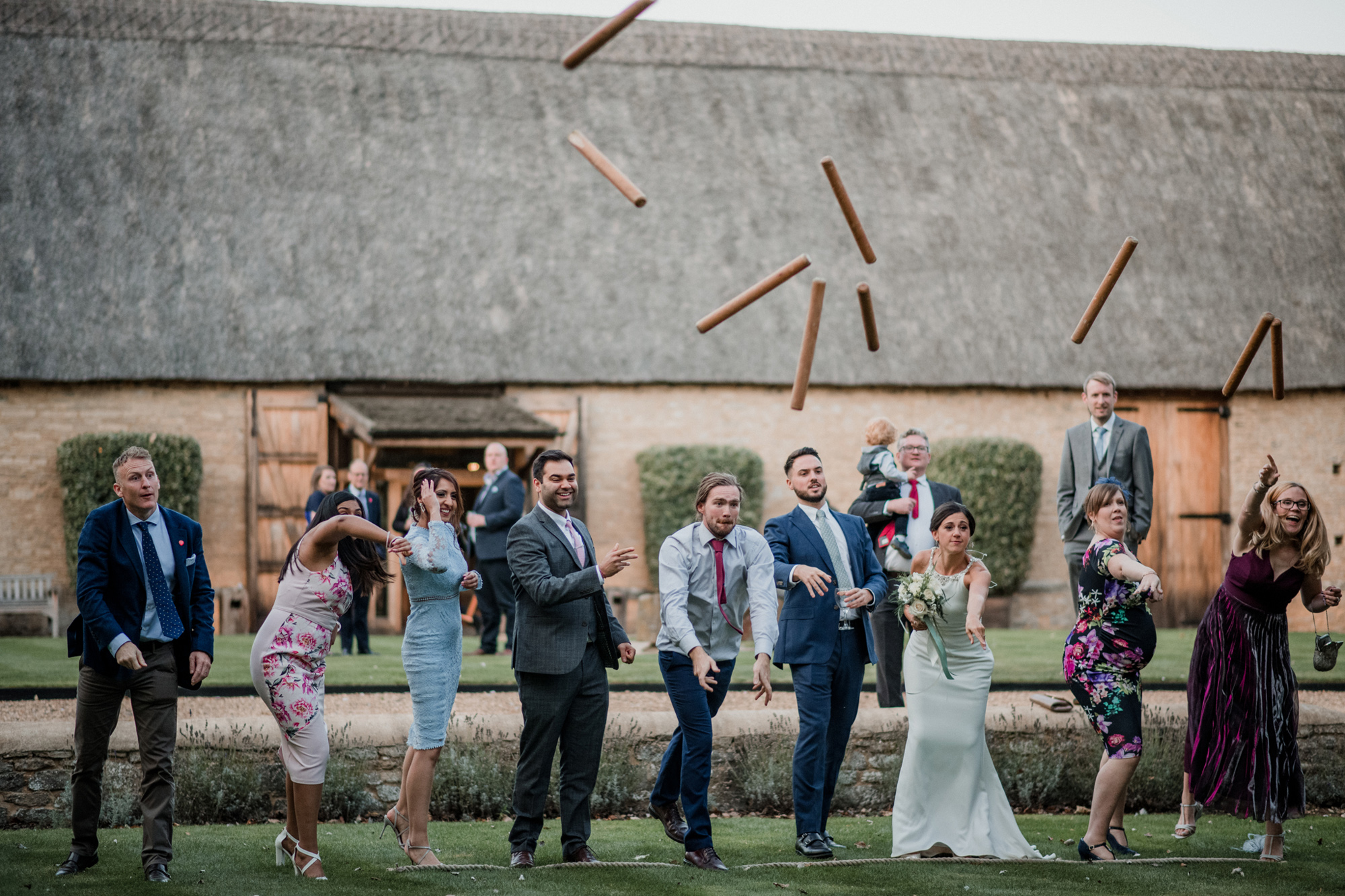 The New Wedding Aesthetic: A Sense of Home 25 Wedding guests playing lawn games at Tythe, Oxfordshire barn wedding venue.