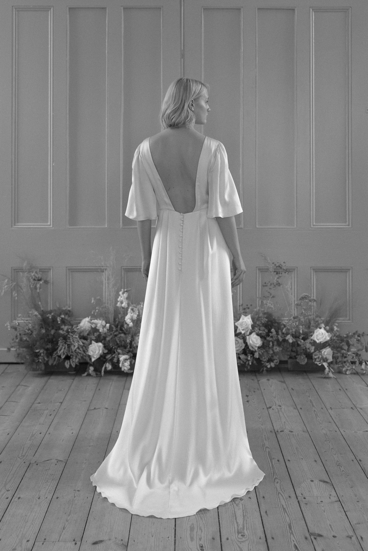 Backless Kate Beaumont ethical silk wedding dress with shoulder length sleeves.