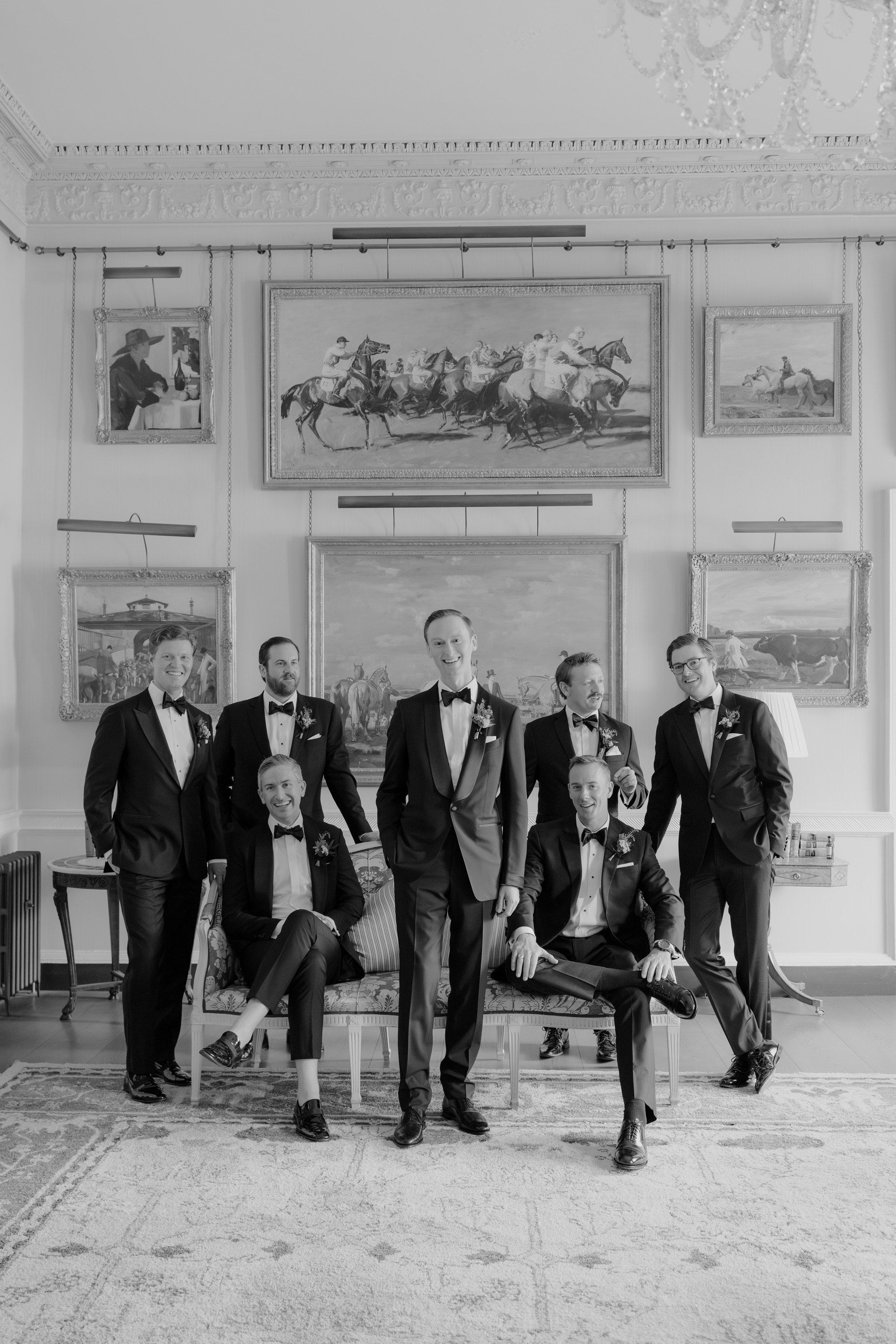 Group portrait of a groom and his groomsmen in elegant black tie.