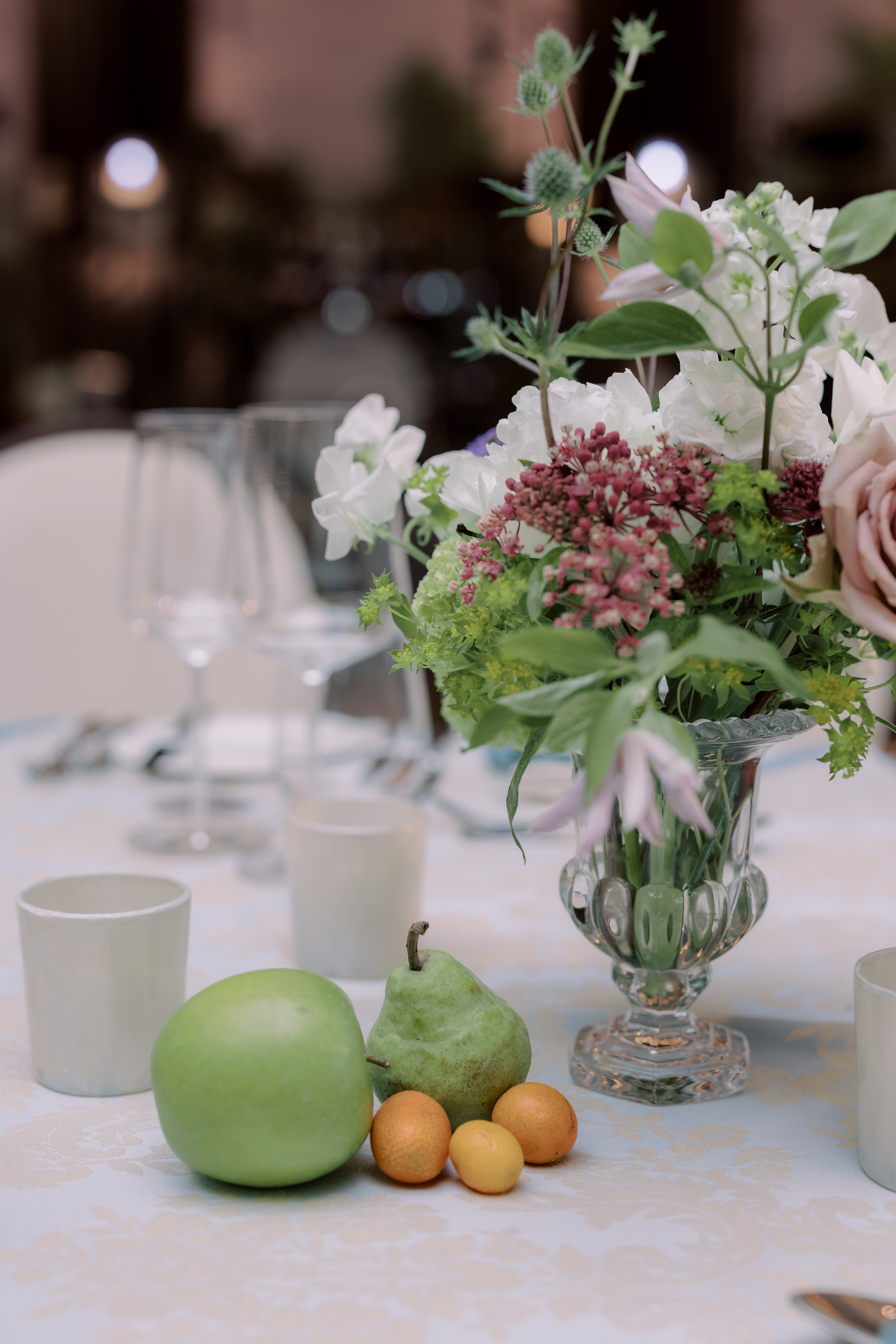 Apples, pears and apricots used as table decor with elegant seasonal summer flowers.
