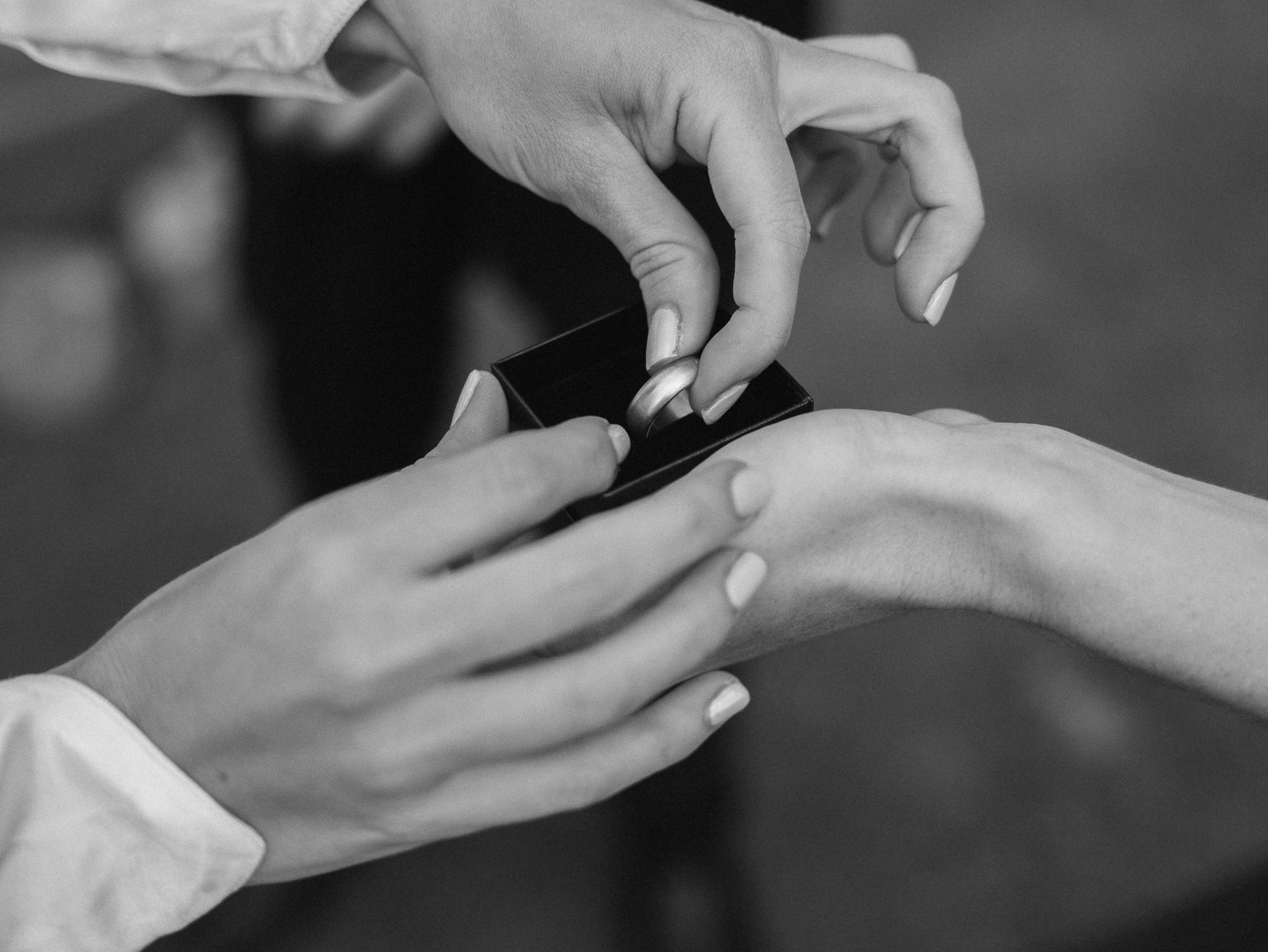 Romantic Tuscan Elopement on Film 153 - An Original 1940s Vintage Dress for Emily & Ned's Intimate Elopement in Tuscany Close up shot of the bride's hands lifting the groom's ring out of the ring box during the wedding ceremony.