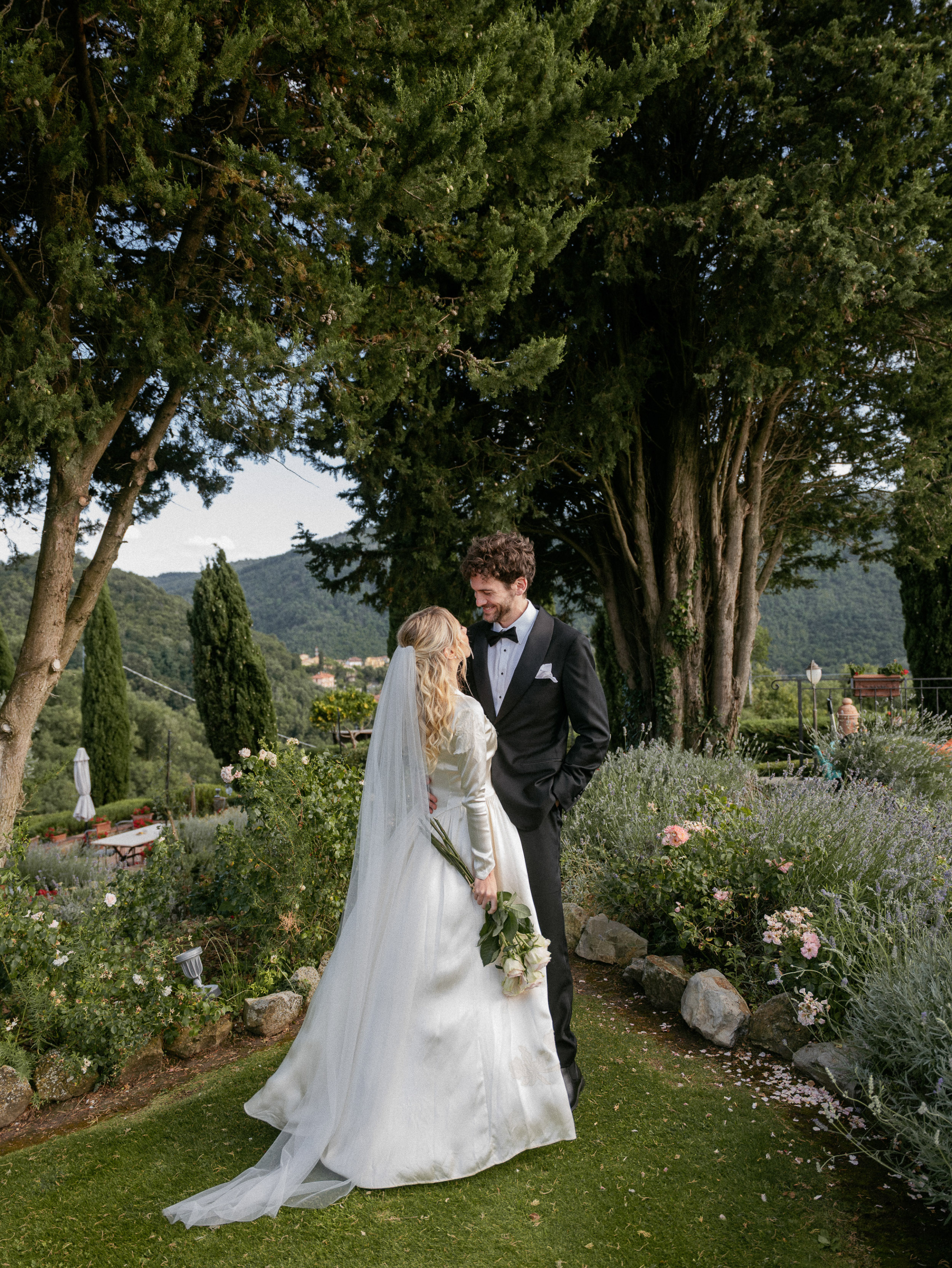 Romantic Tuscan Elopement on Film 187 1 - An Original 1940s Vintage Dress for Emily & Ned's Intimate Elopement in Tuscany Bride in an original 1940's vintage silk wedding dress standing with her groom in black tie in the gardens of an Italian villa for their Tuscan elopement.