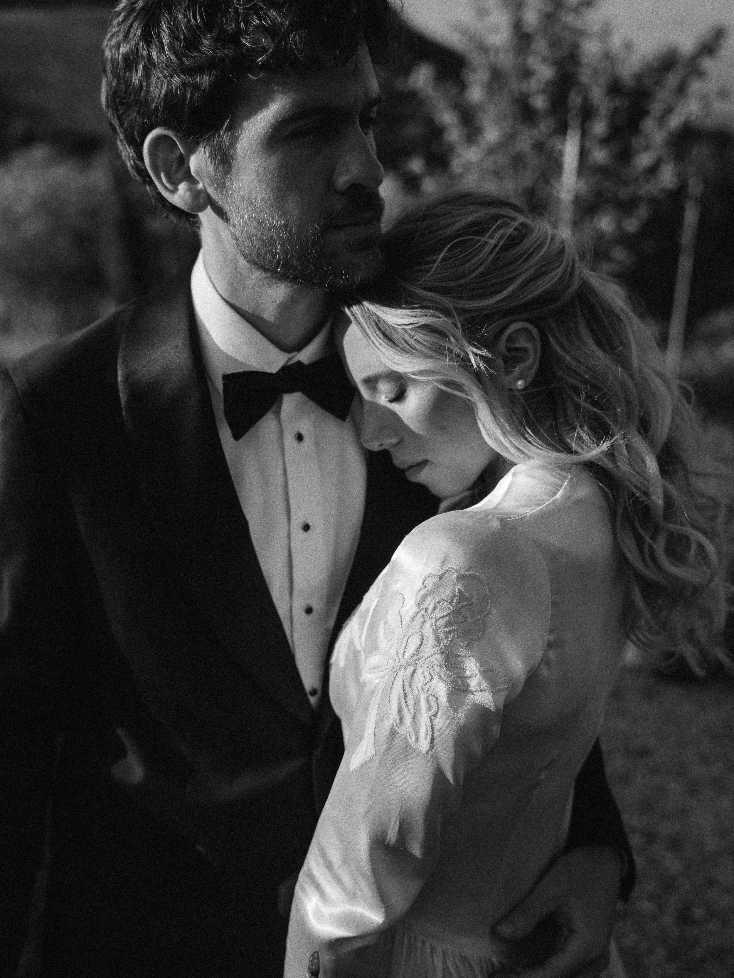 Romantic Tuscan Elopement on Film 221 - An Original 1940s Vintage Dress for Emily & Ned's Intimate Elopement in Tuscany Intimate black and white portrait of groom kissing his bride's head as he holds her close.