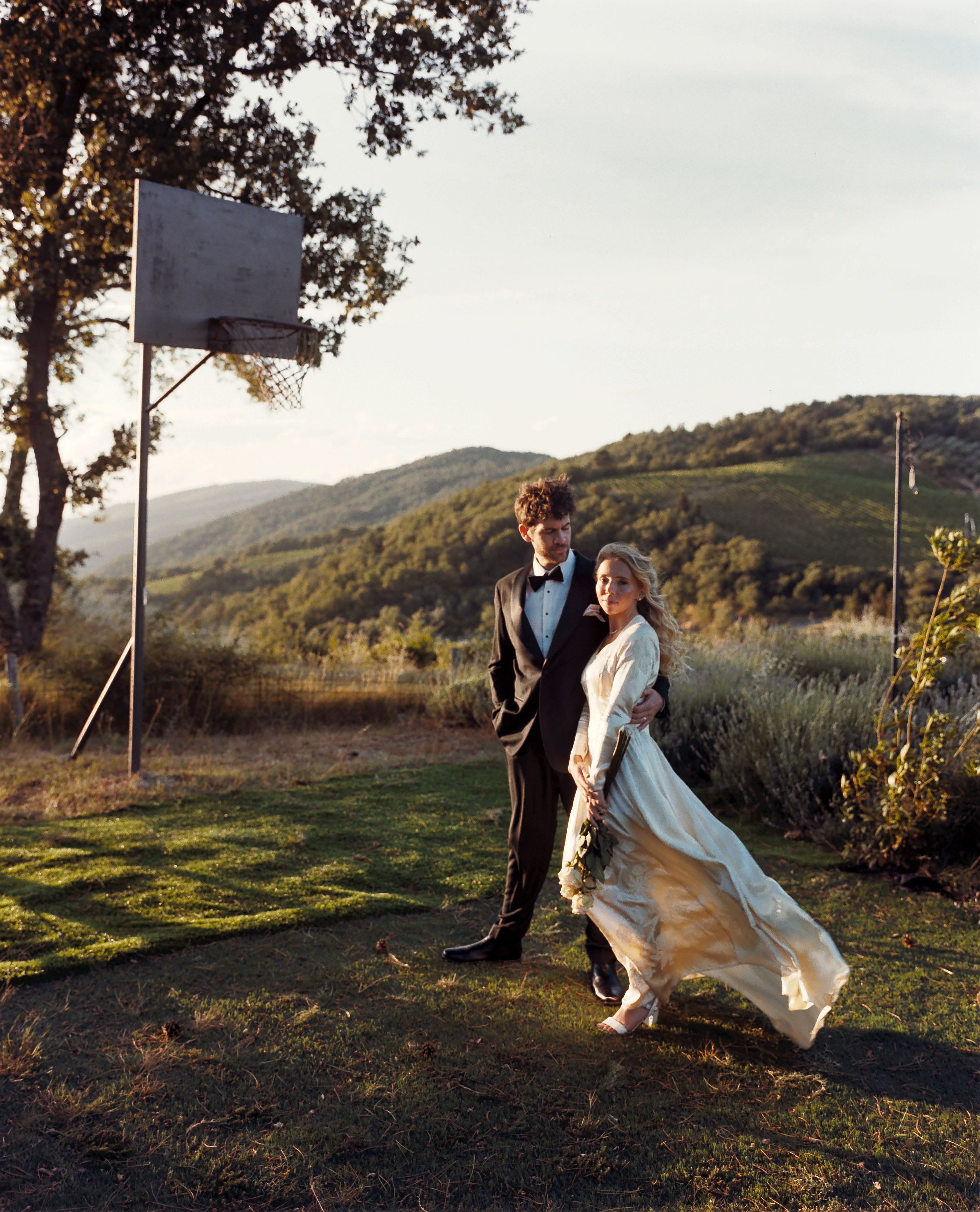 Romantic Tuscan Elopement on Film 299 - An Original 1940s Vintage Dress for Emily & Ned's Intimate Elopement in Tuscany Bride in a 1940's original silk vintage wedding dress with long pointed sleeves, walking with her groom in black tie. Elopement in Tuscany.