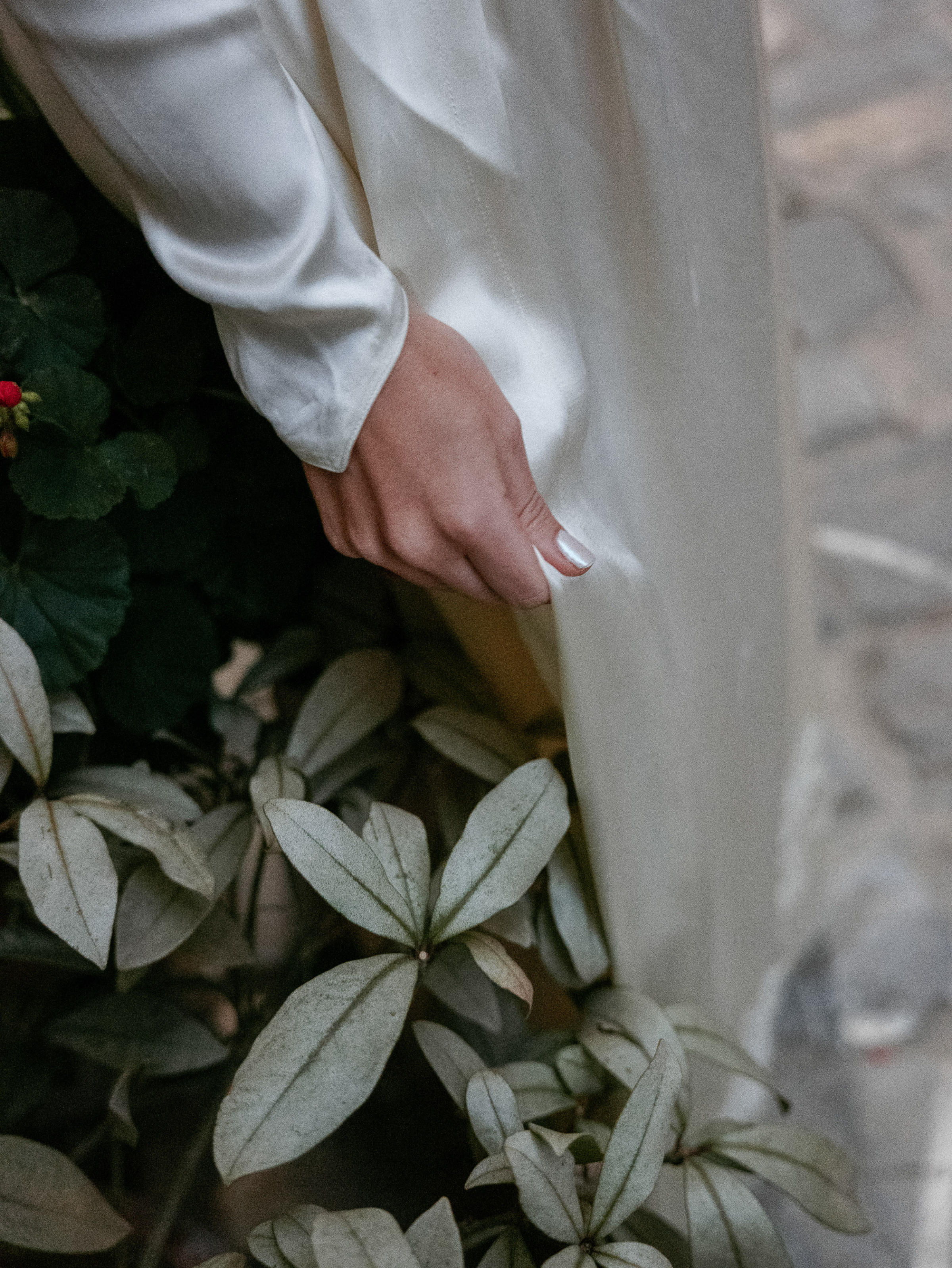 Romantic Tuscan Elopement on Film 338 - An Original 1940s Vintage Dress for Emily & Ned's Intimate Elopement in Tuscany Closeup shot of bride wearing an original 1940's silk vintage wedding dress - pearlised nail polish and long pointed sleeves.