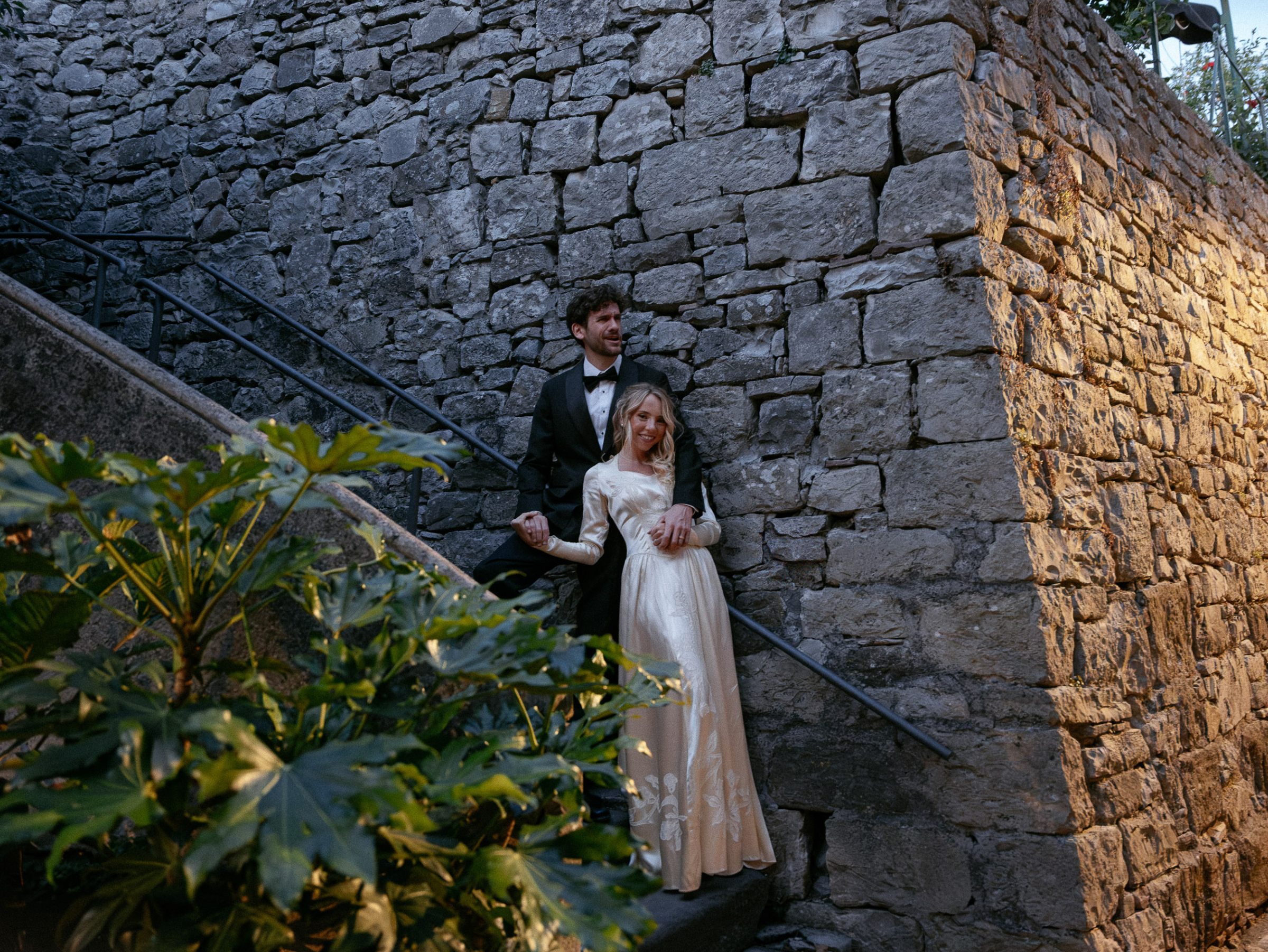 Romantic Tuscan Elopement on Film 341 - An Original 1940s Vintage Dress for Emily & Ned's Intimate Elopement in Tuscany Bride in an original 1940's vintage silk wedding dress posing on steps in the town of their Tuscan elopement. Groom in black tie.