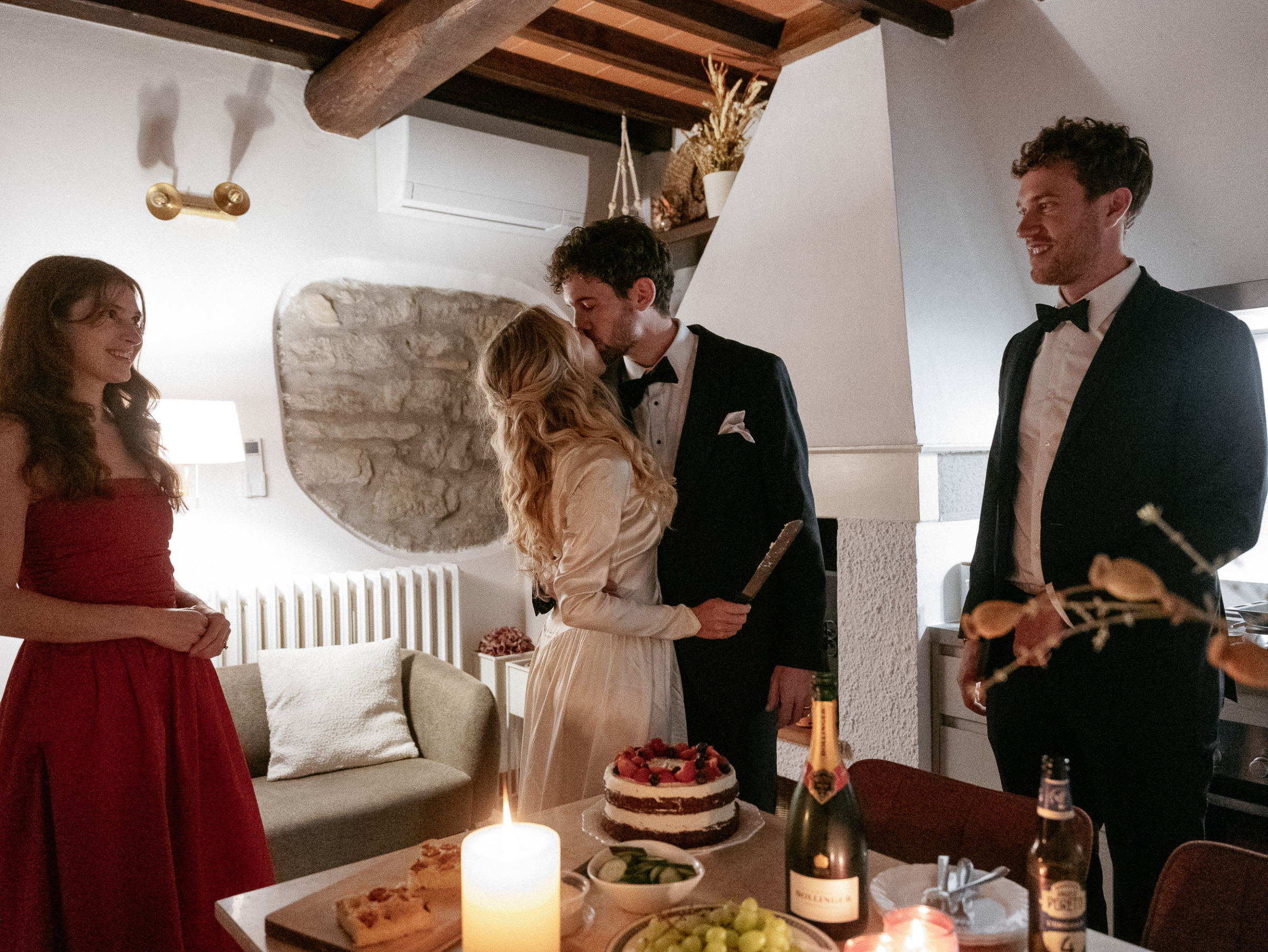 Romantic Tuscan Elopement on Film 371 - An Original 1940s Vintage Dress for Emily & Ned's Intimate Elopement in Tuscany Bride in an original 1940's silk vintage wedding dress holding a knife to cut the cake with her groom in black tie. They are accompanies by their two best friends.