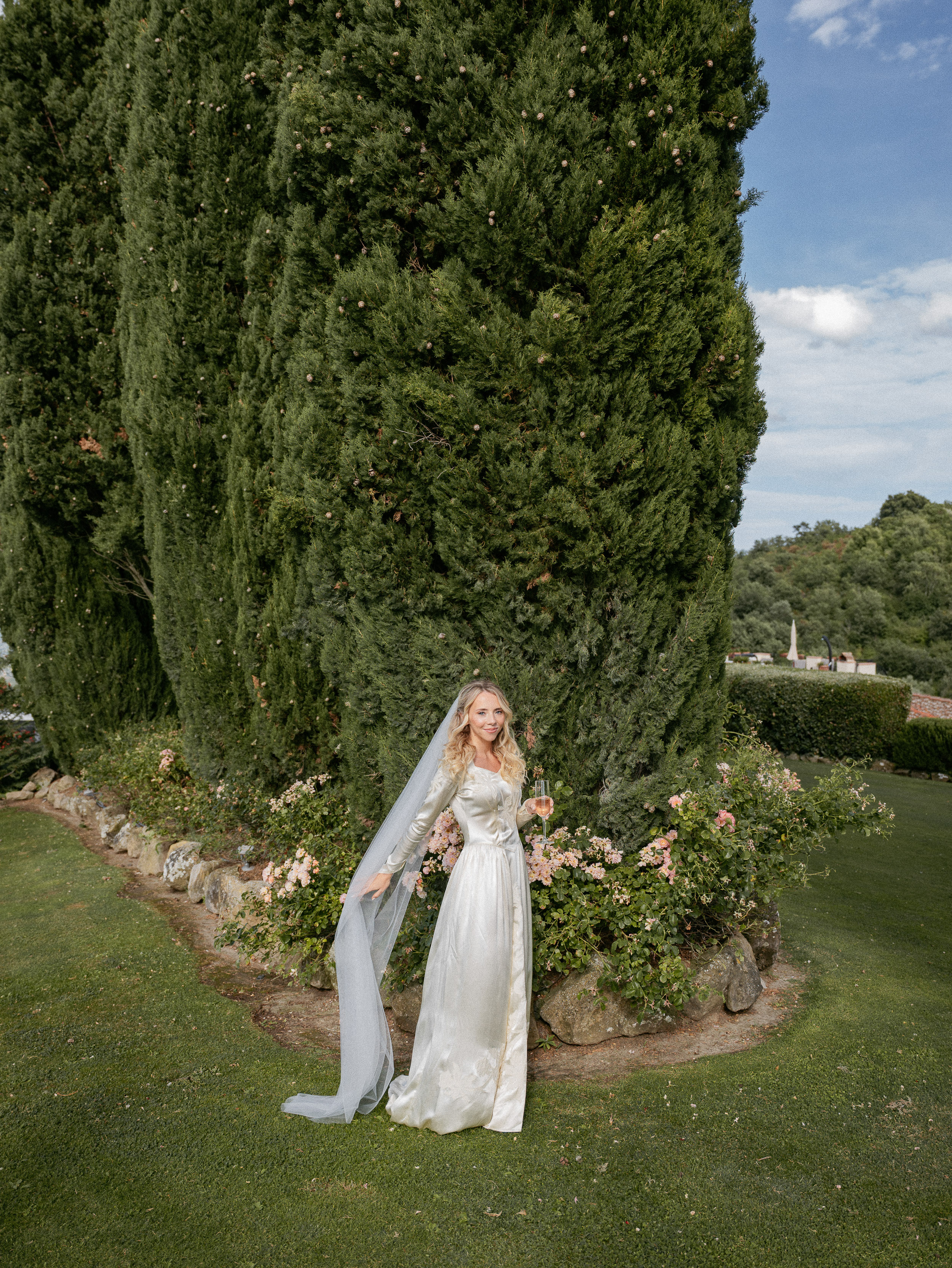 Romantic Tuscan Elopement on Film 44 - An Original 1940s Vintage Dress for Emily & Ned's Intimate Elopement in Tuscany Bride with long blonde hair wearing a 1940's original vintage wedding dress. She stands in the gardens of a villa in Tuscany, Italy.