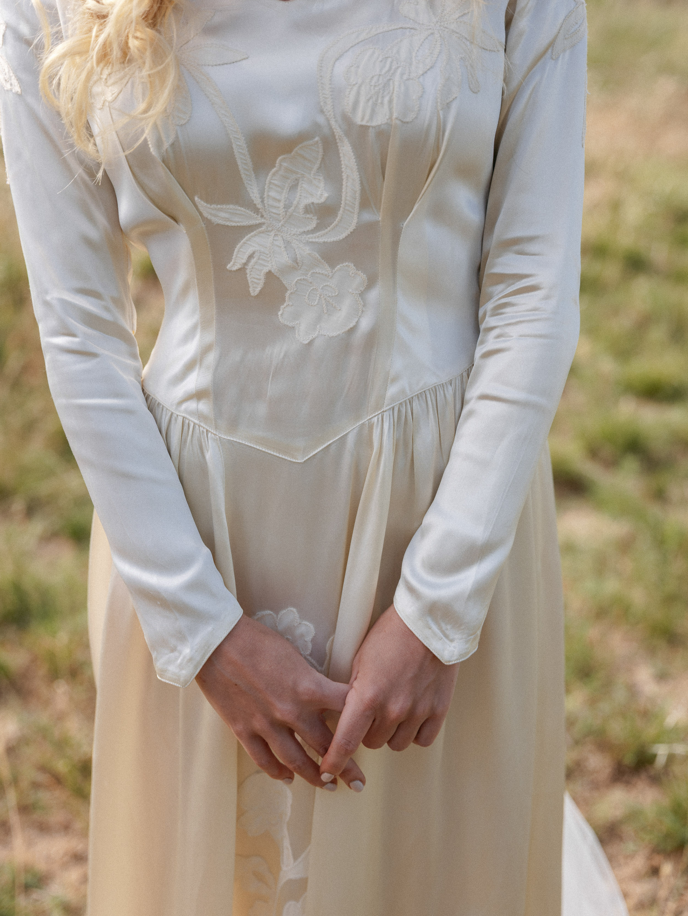 Romantic Tuscan Elopement on Film 68 - An Original 1940s Vintage Dress for Emily & Ned's Intimate Elopement in Tuscany Closeup torso shot of a bride wearing a 1940's original vintage wedding dress with long pointed sleeves.