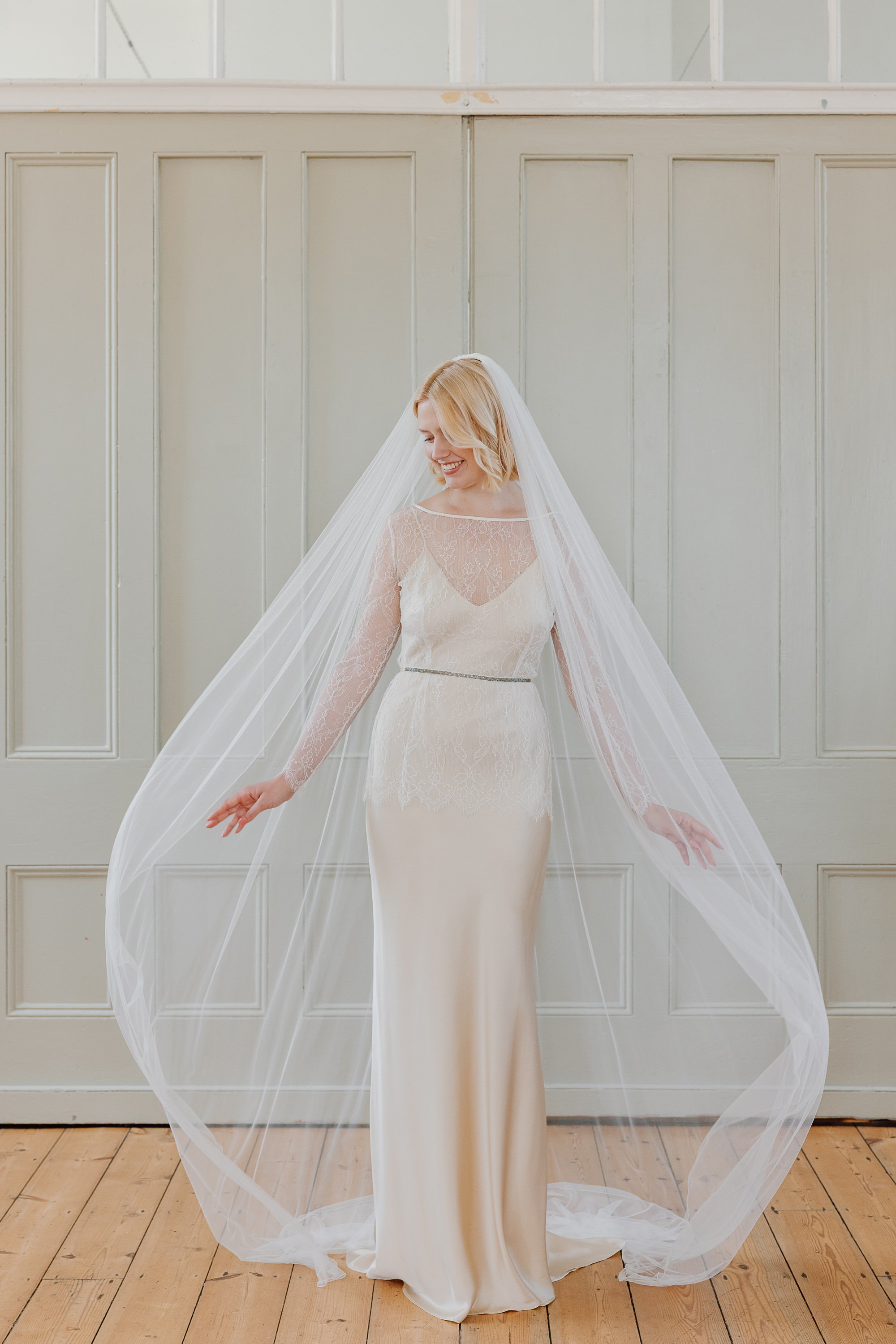 Thistle silk slip wedding dress lace long sleeve bridal top bridal separates KateBeaumont Icons 2 IndiaHobson HR 92 - Kate Beaumont: Lovingly Handmade Silk Wedding Dresses Blonde haired bride wearing a silk Kate Beaumont wedding dress with delicate lace coverup and long simple veil.