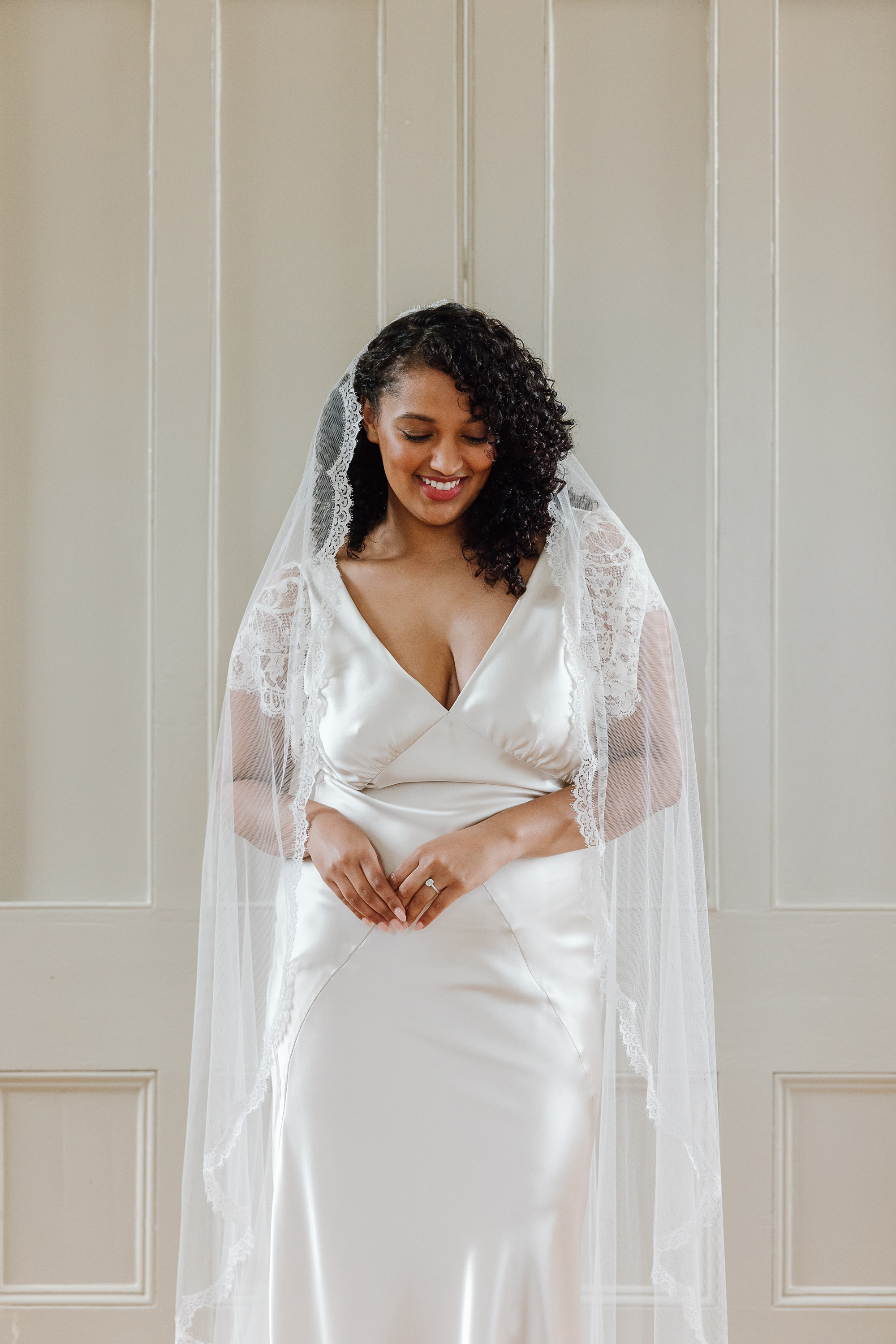 Viola bias cut silk wedding gown KateBeaumont Icons 1 IndiaHobson HR 259 - Kate Beaumont: Lovingly Handmade Silk Wedding Dresses Black curvy bride wearing a Kate Beaumont wedding dress with lace trimmed veil.