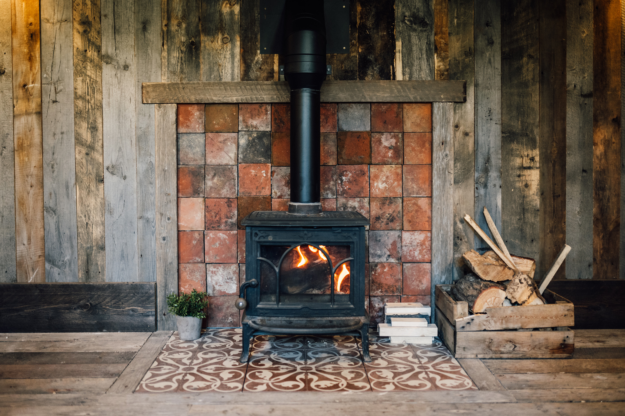 The New Wedding Aesthetic: A Sense of Home 50 Traditional stove wooden fireplace at Tythe, Oxfordshire barn wedding venue.