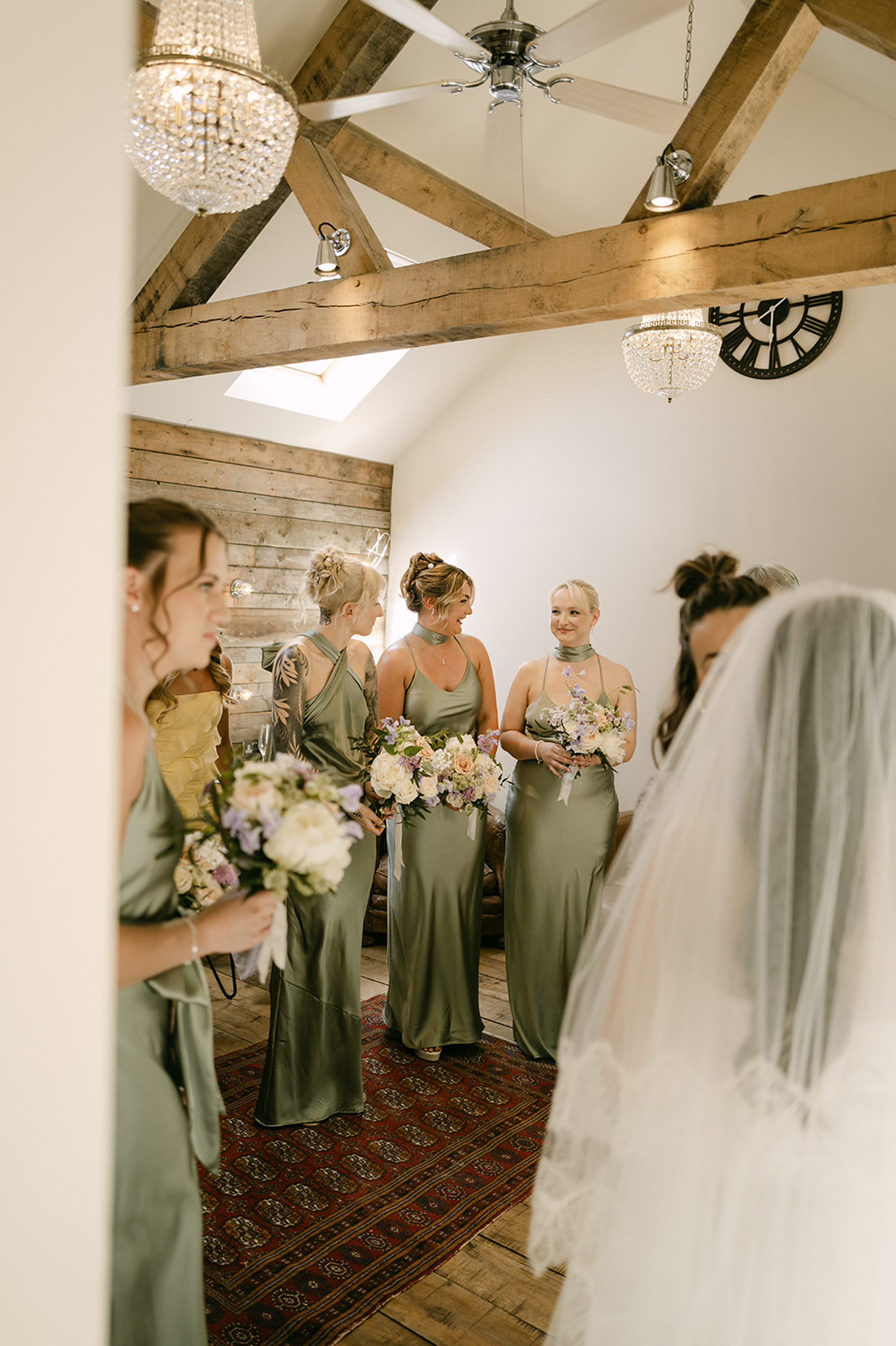 The New Wedding Aesthetic: A Sense of Home 6 Brides in pale green satin bridesmaids dresses in different styles at Tythe, Oxfordshire barn wedding venue.